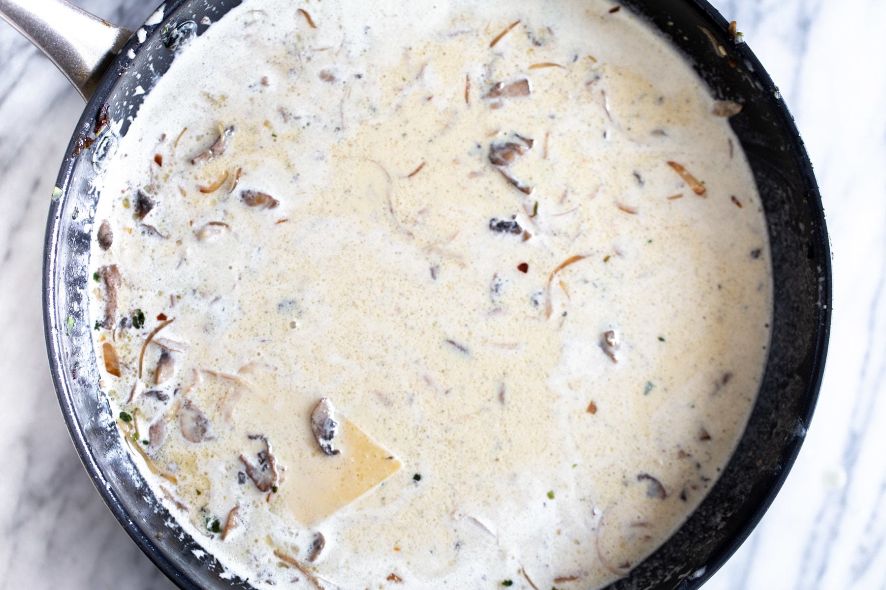 alfredo skillet lasagna ready to be cooked on the stove