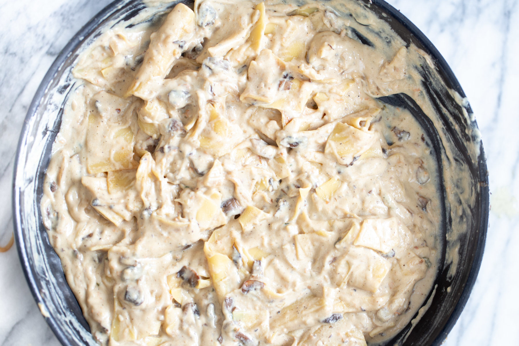 process shot of cooked alfredo skillet lasagna