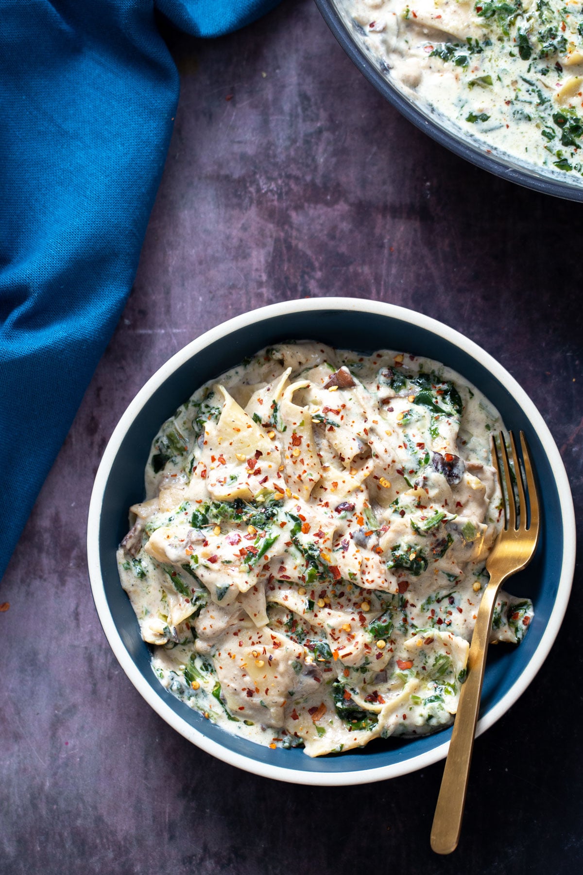 vegan skillet lasagna a blue bowl filled with vegan alfredo skillet lasagna