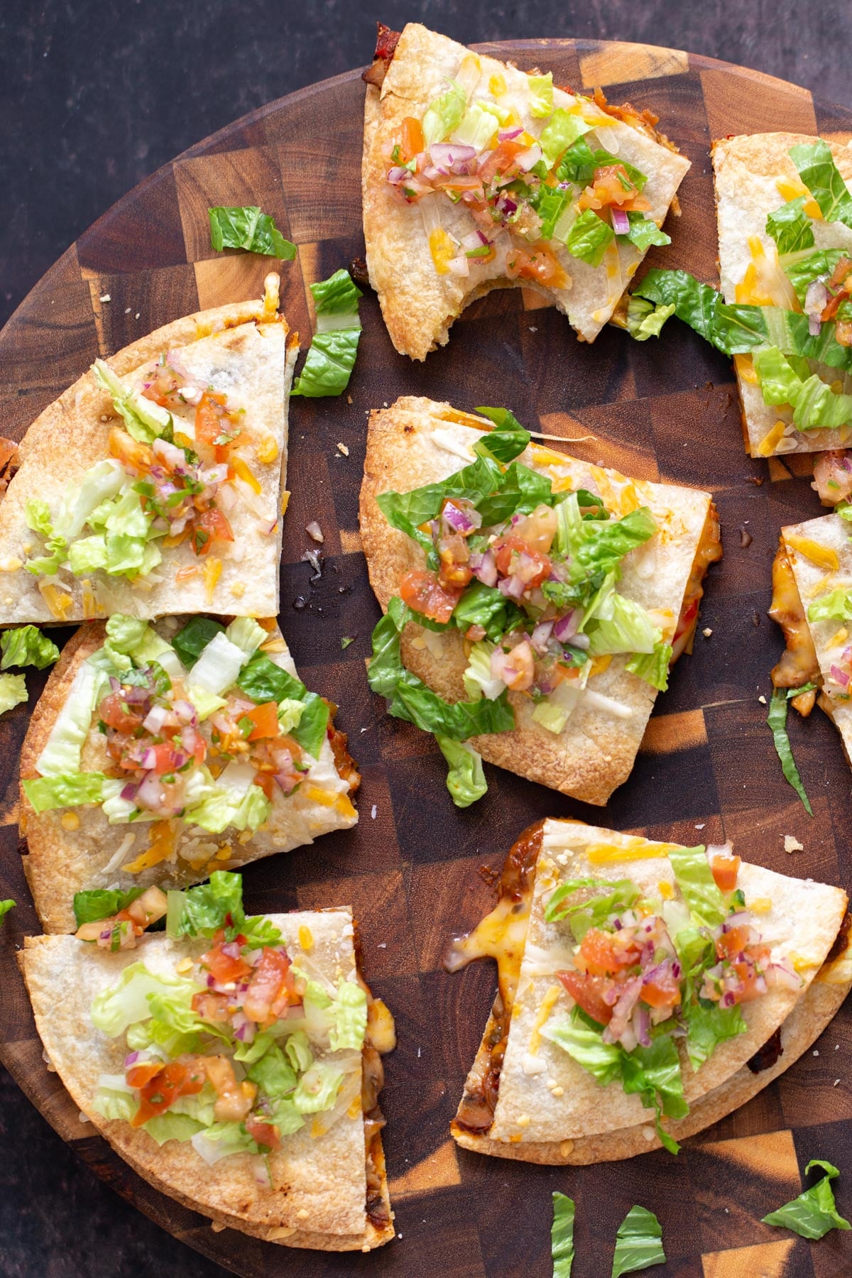vegan tostadas vegan mushroom and bell pepper tostadas cut into wedges and served on a wooden board
