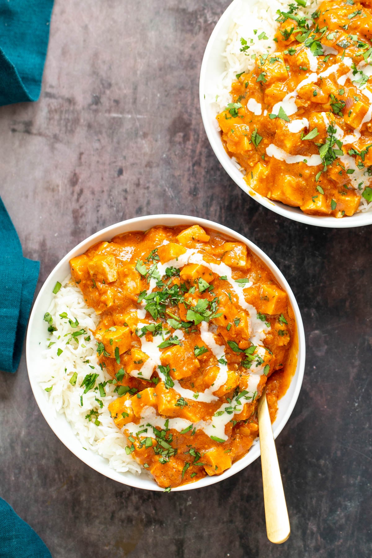 baked tofu curry two servings of vegan baked tofu curry served with rice and sprinkled with fresh herbs