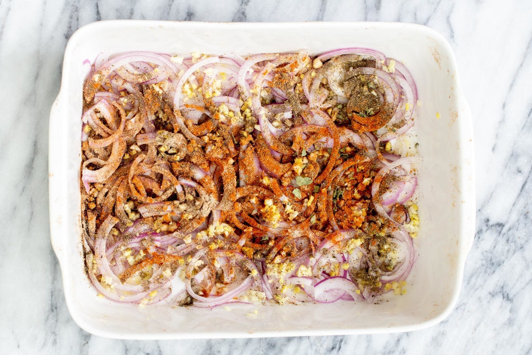 vegetable balti onions, garlic and ginger in a casserole dish