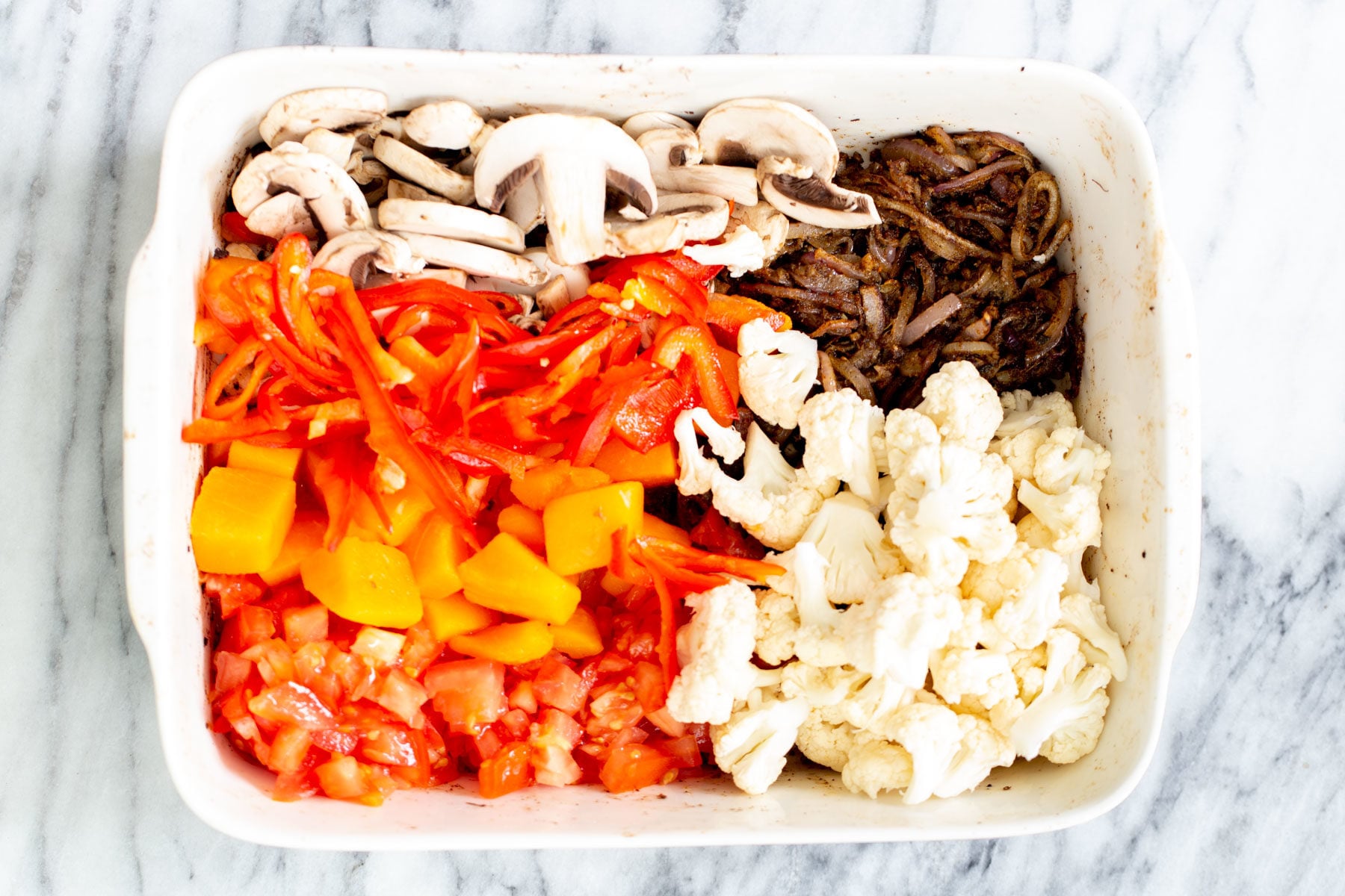 Vegetable Balti healthy vegetables assembled in a casserole dish to make balti vegetables