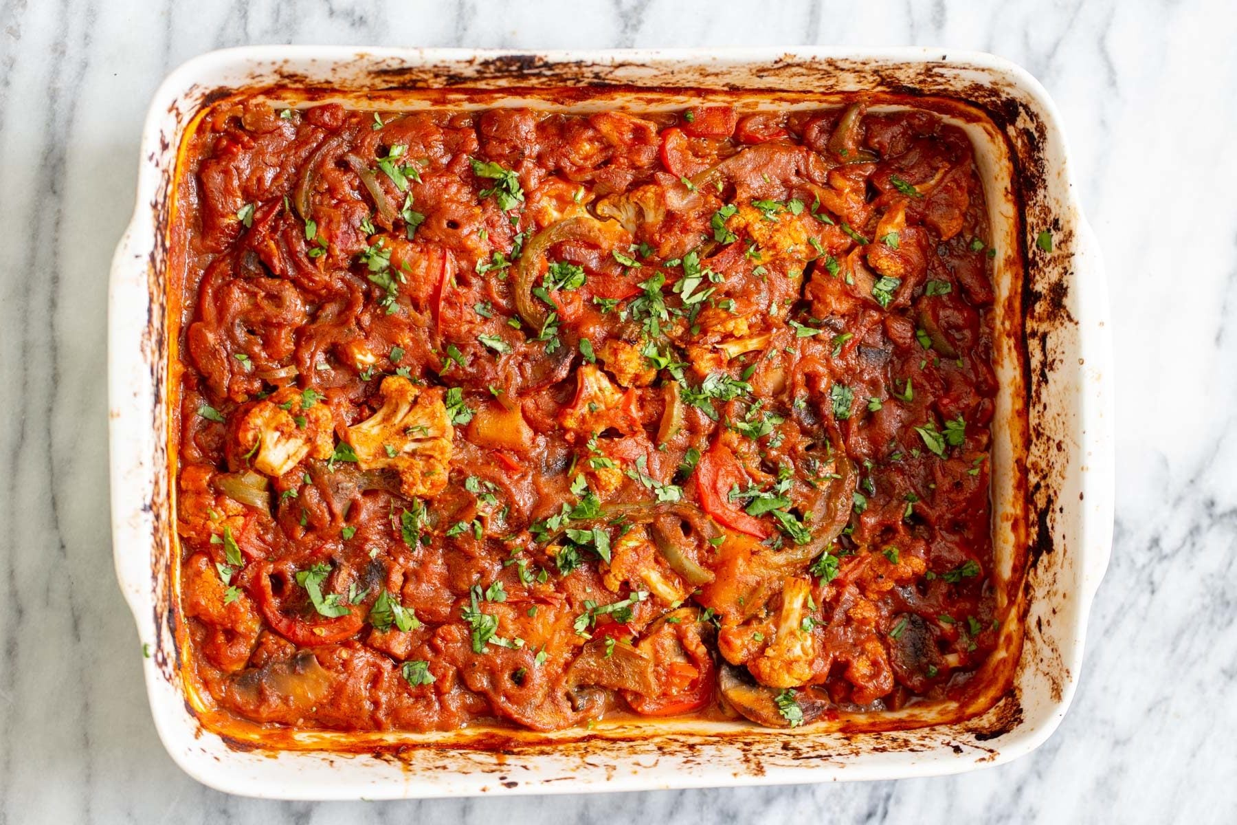 vegetable balti freshly baked Indian vegetable balti in a white casserole dish