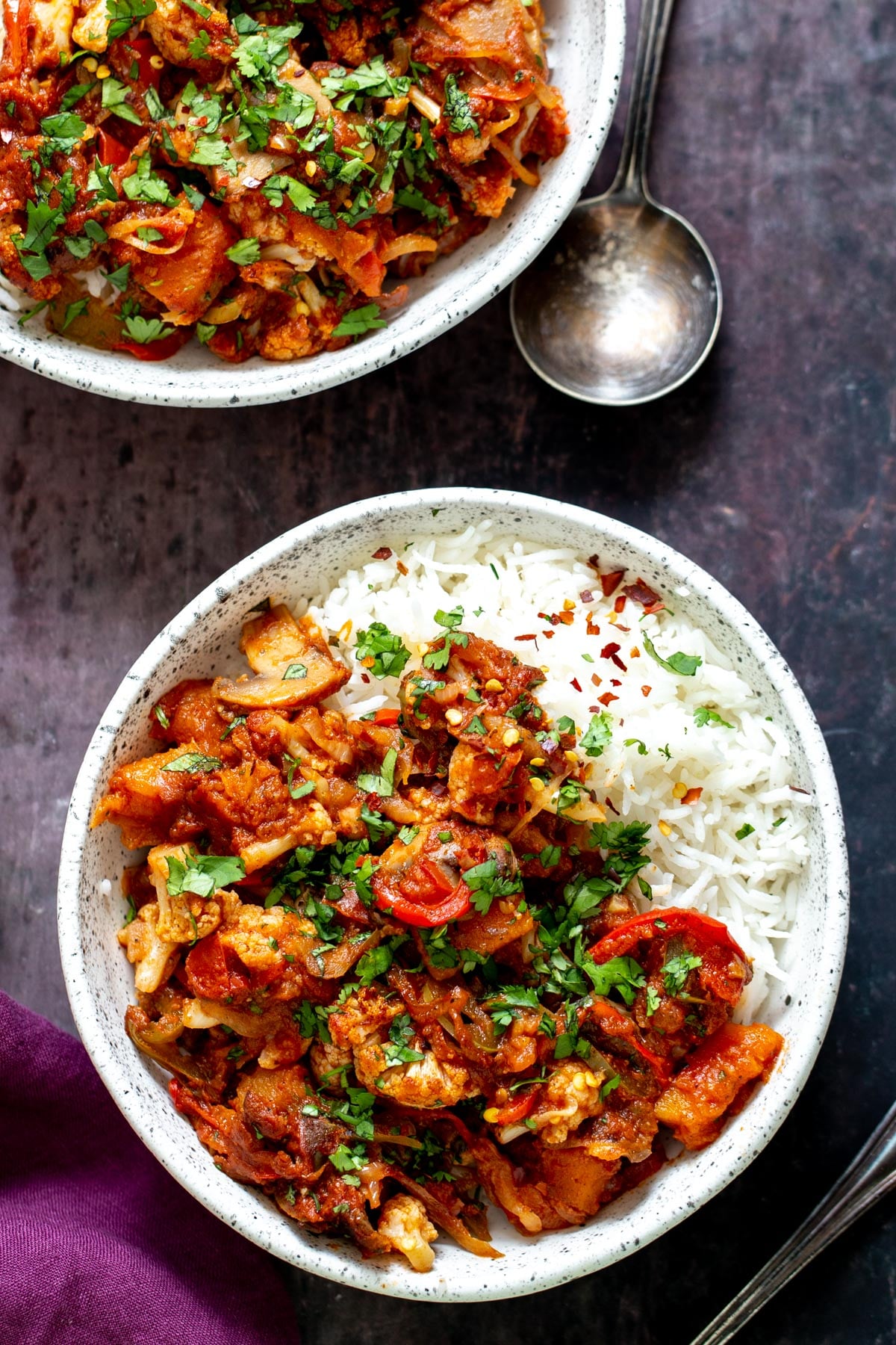 vegetable balti a bowl of vegetable balti served with rice and sprinkled with fresh parsley