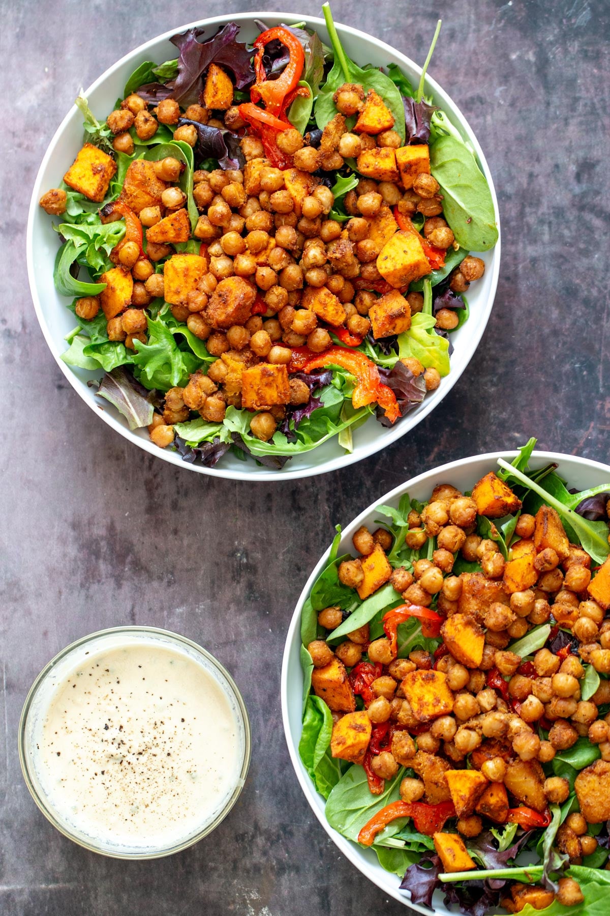sweet potato chickpea salad sweet potato chickpea salad in two bowls with a small side dish with tahini sauce