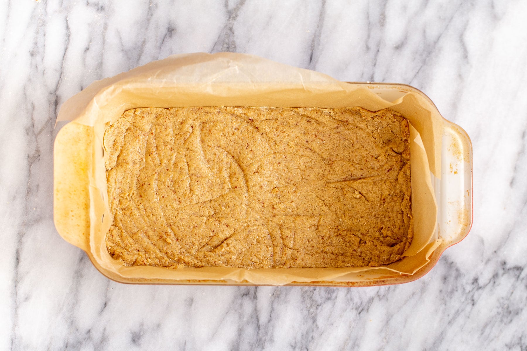 vegan lemon bars vegan cookie crust pressed in a pyrex loaf pan