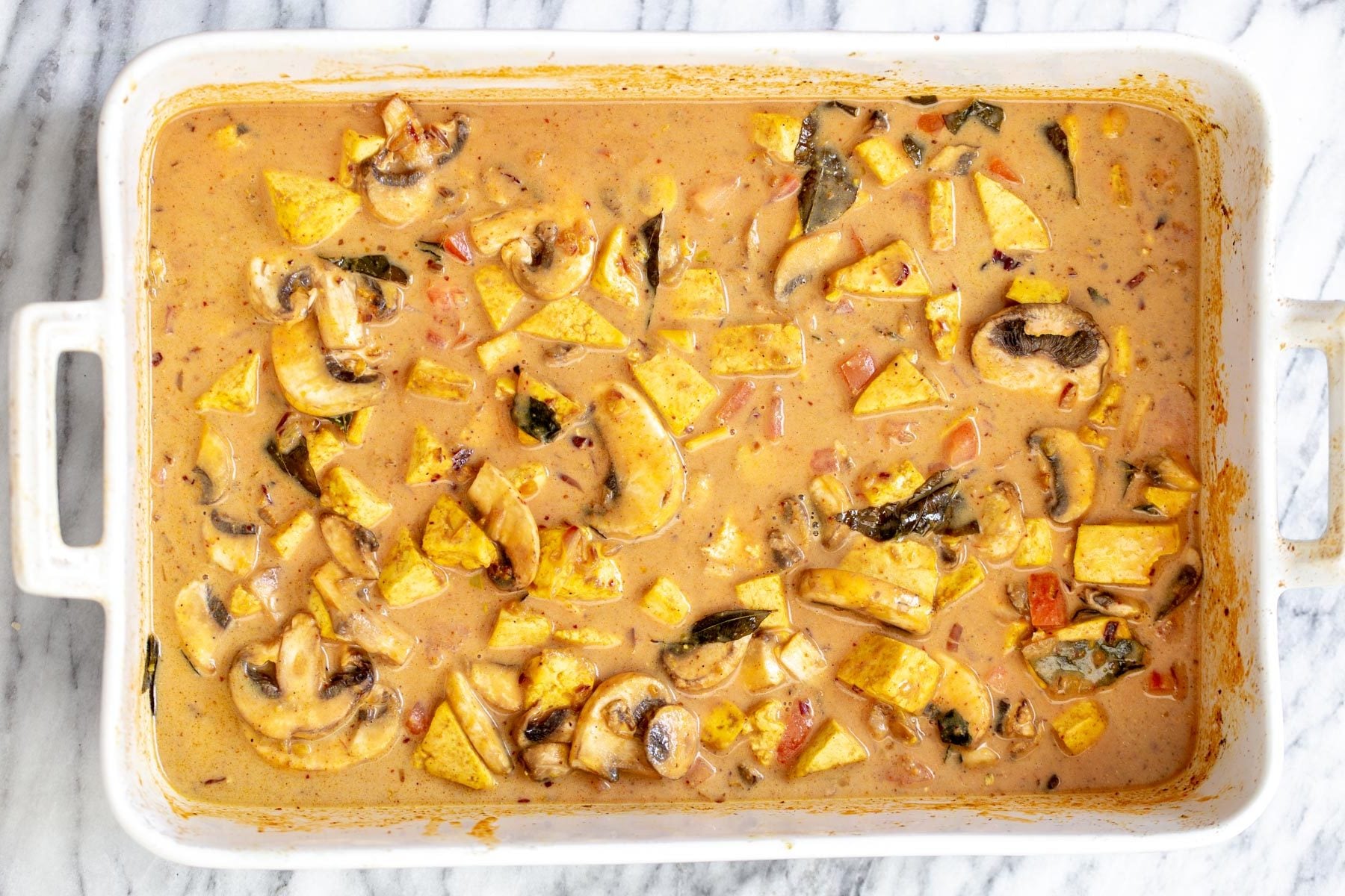 Indian coconut milk and curry tofu casserole ready for baking