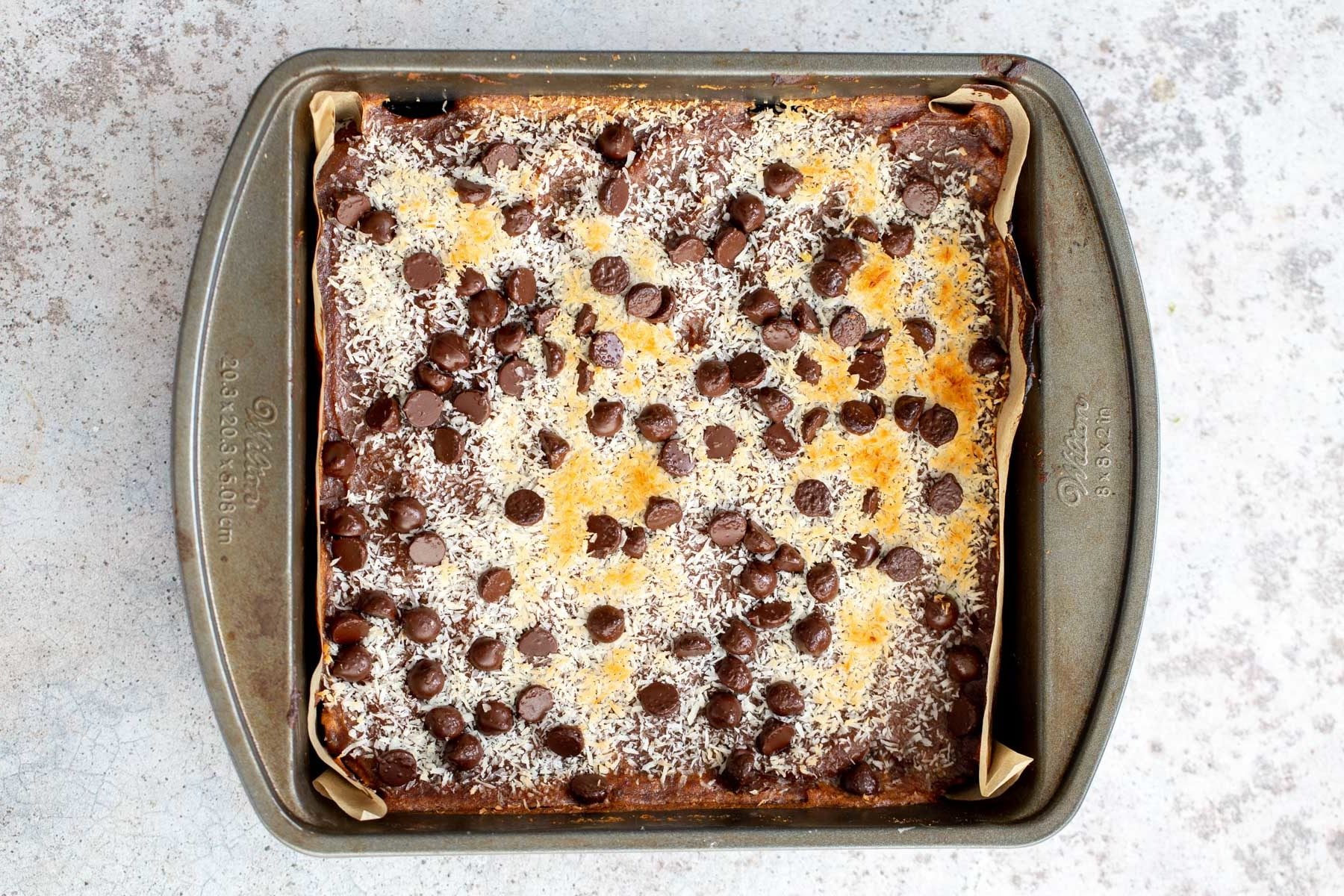 a square baking pan with vegan caramel oatmeal snack bars