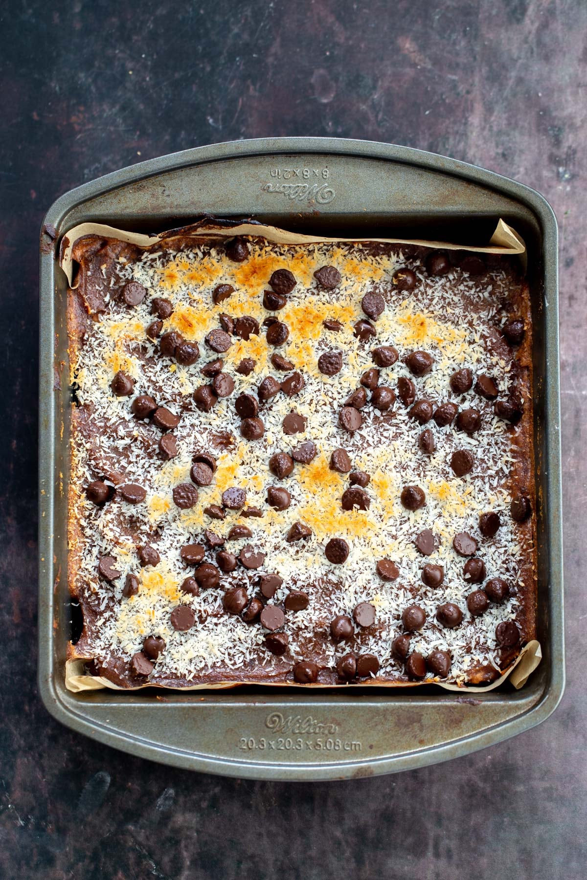 freshly baked vegan carmelita oatmeal caramel bars in a baking pan
