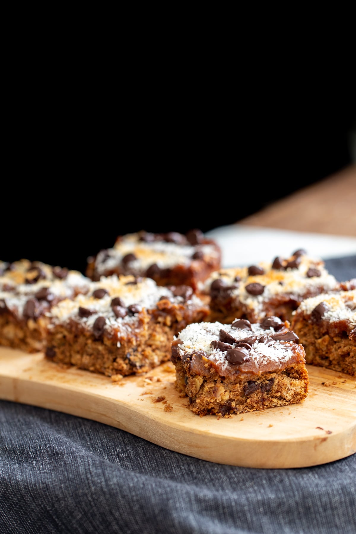 vegan oatmeal date caramel bars on a wooden board
