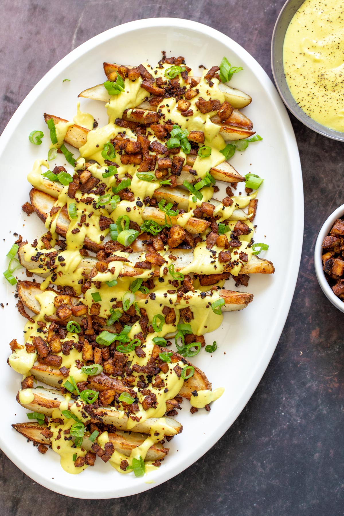 loaded potato wedges crispy vegan baked loaded fries topped with vegan cheese sauce and tofu bacon bits