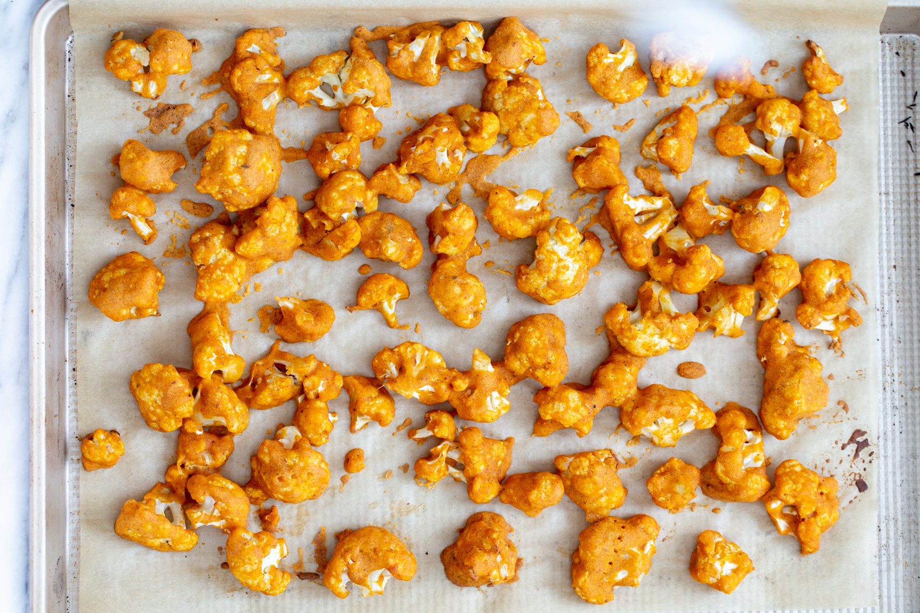cauliflower wings baked breaded cauliflower wings on a baking sheet