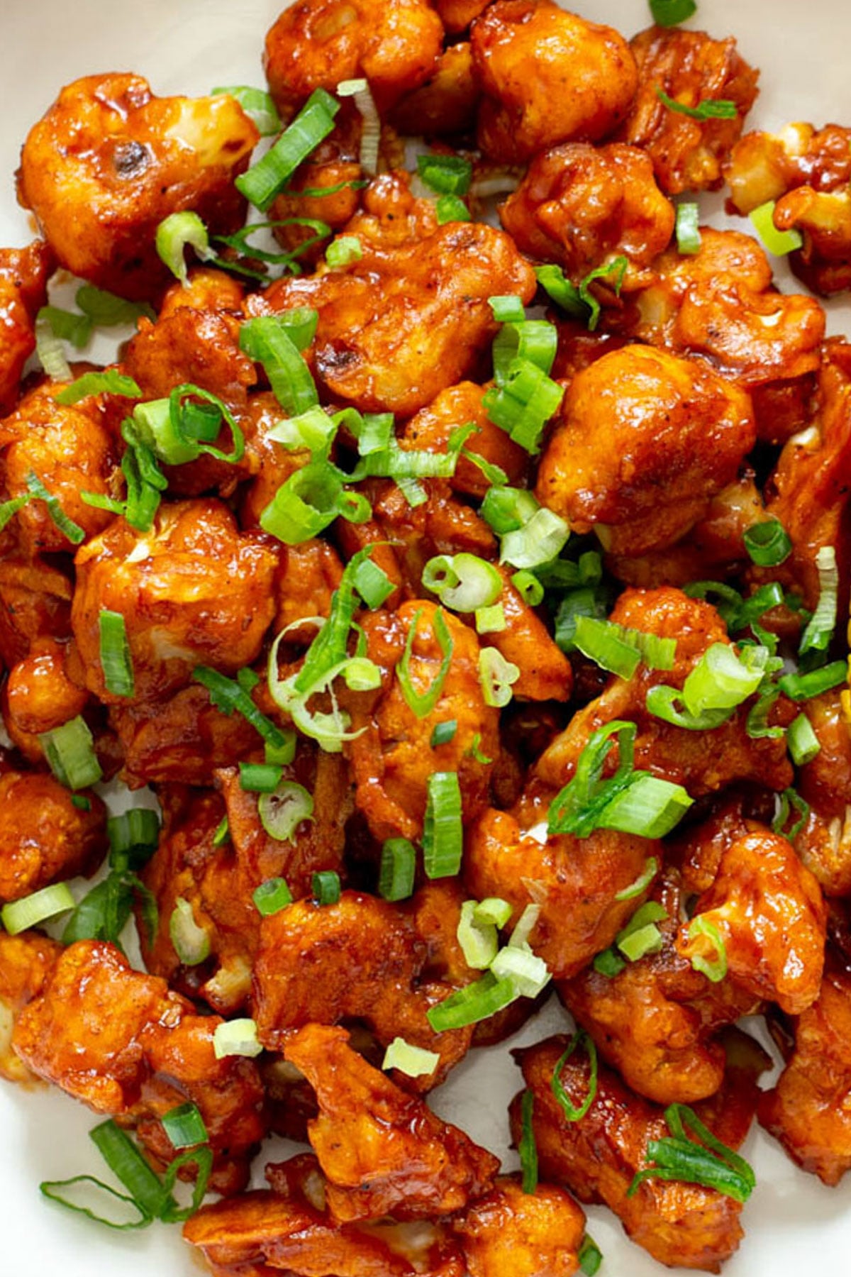 baked beer battered cauliflower wings sprinkled with chopped green onion 