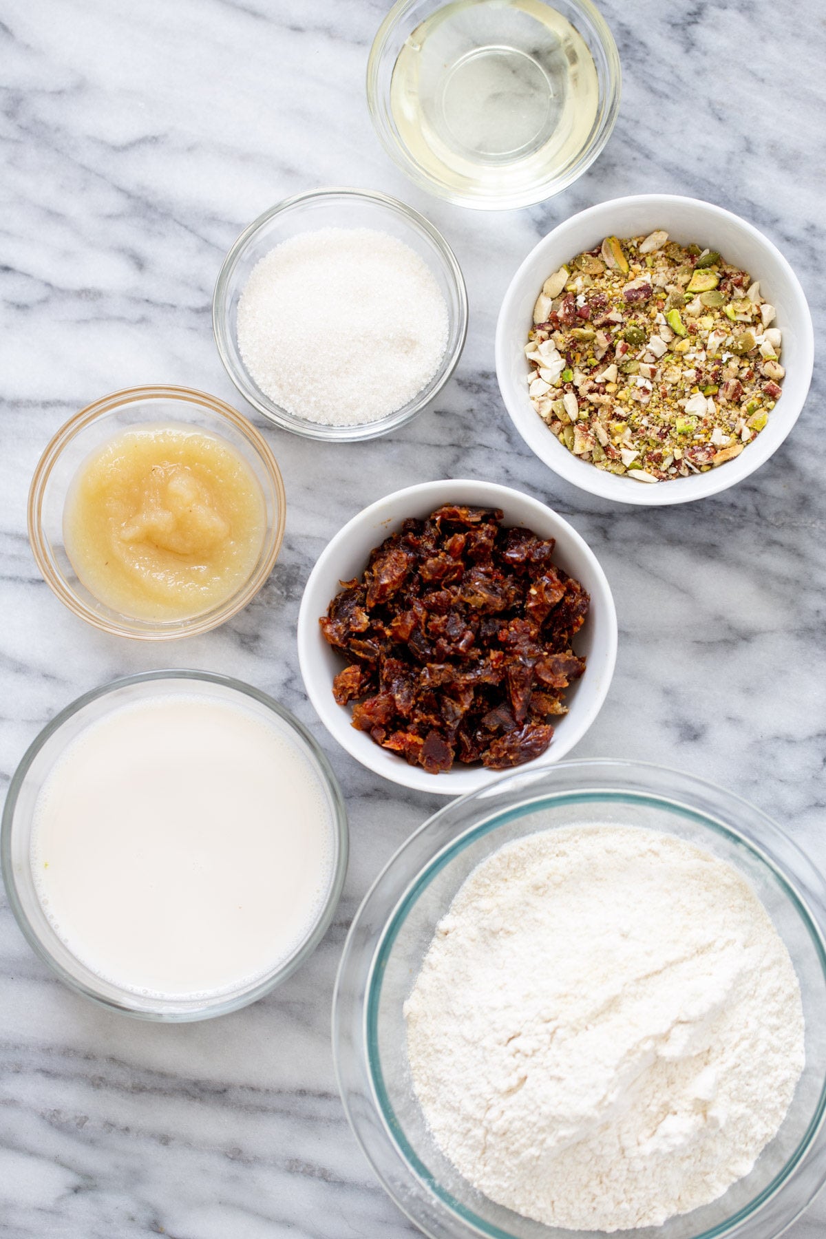 date nut cake ingredients for vegan date nut cake on a marble countertop