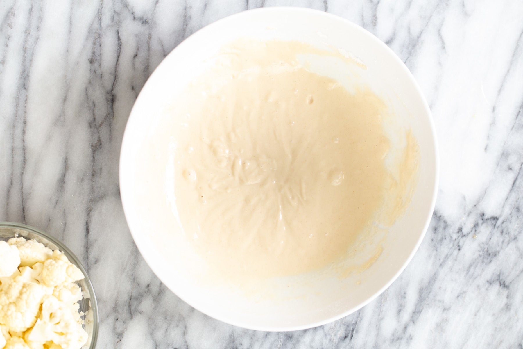cauliflower manchurian batter for cauliflower manchurian in a small white bowl