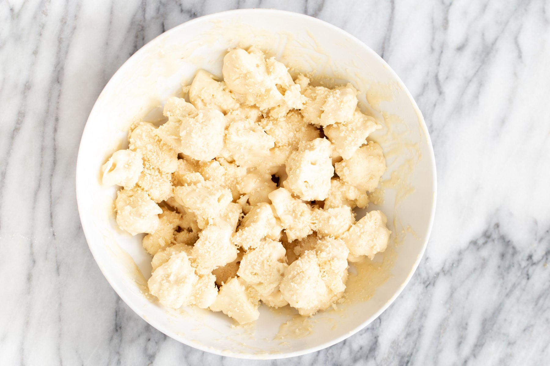 cauliflower manchurian battered cauliflower florets being tossed with panko to make cauliflower manchurian