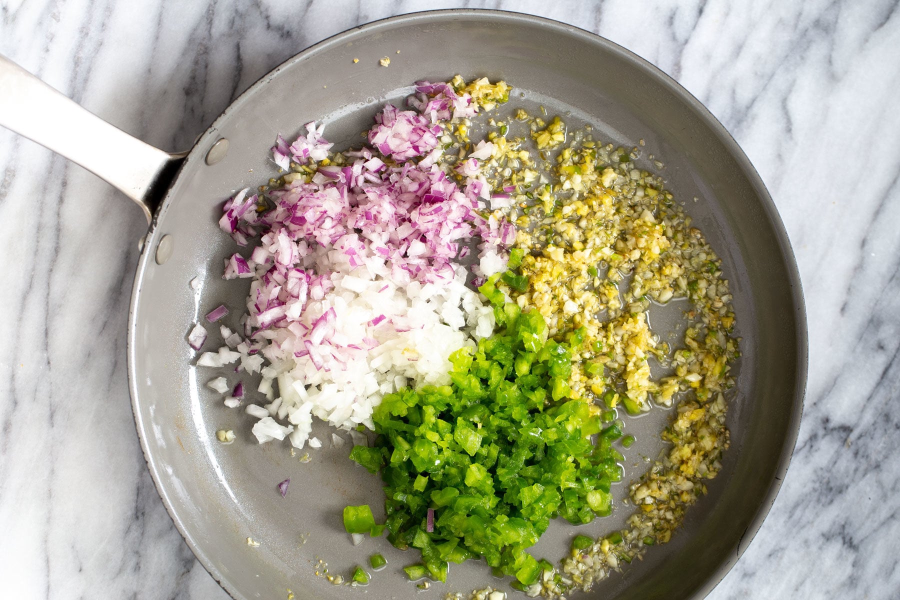 cauliflower manchurian minced chili, garlic, ginger and onions in a sauteeing pan