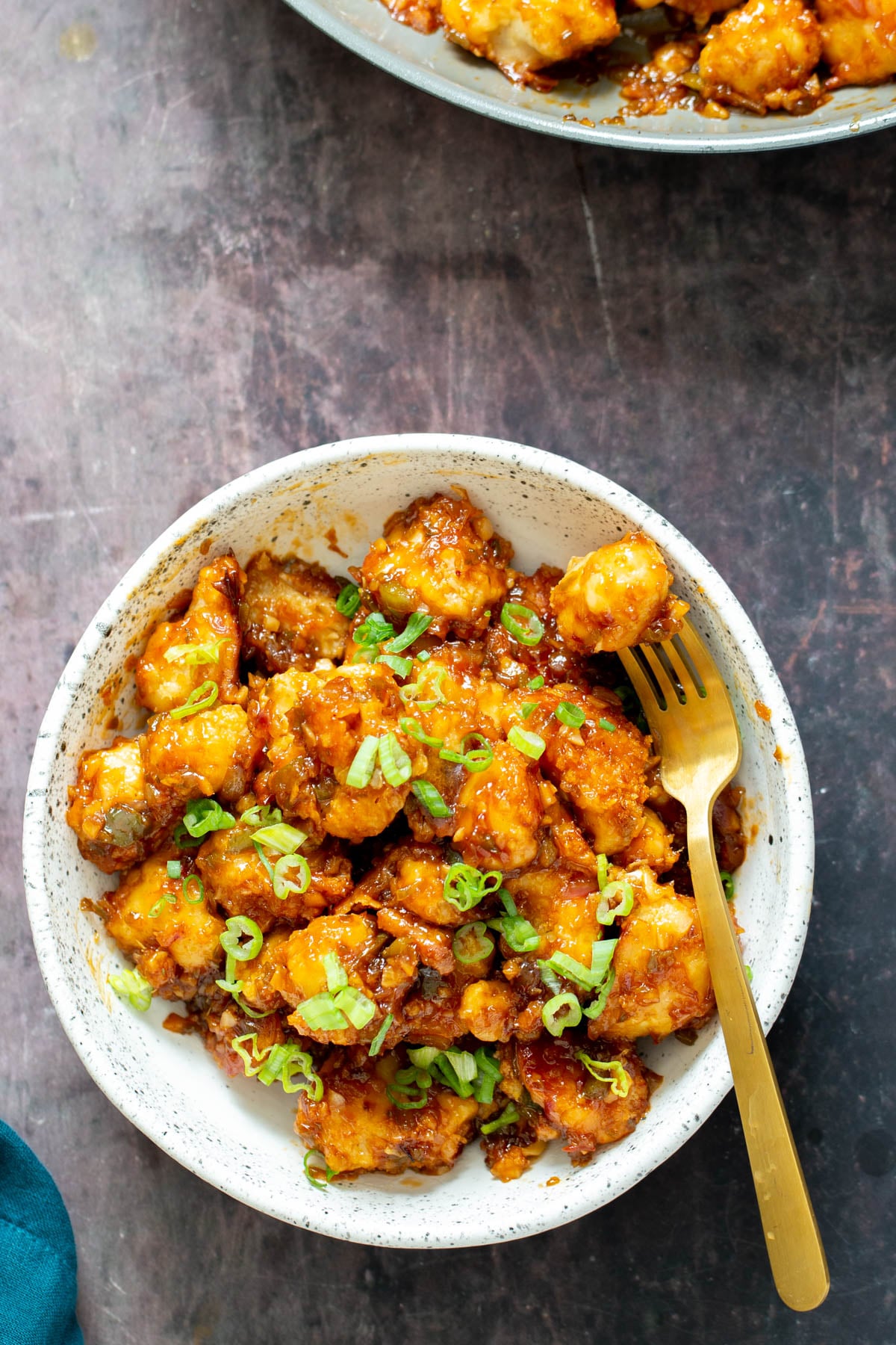 cauliflower manchurian a plate of Cauliflower Manchurian with a fork on the side