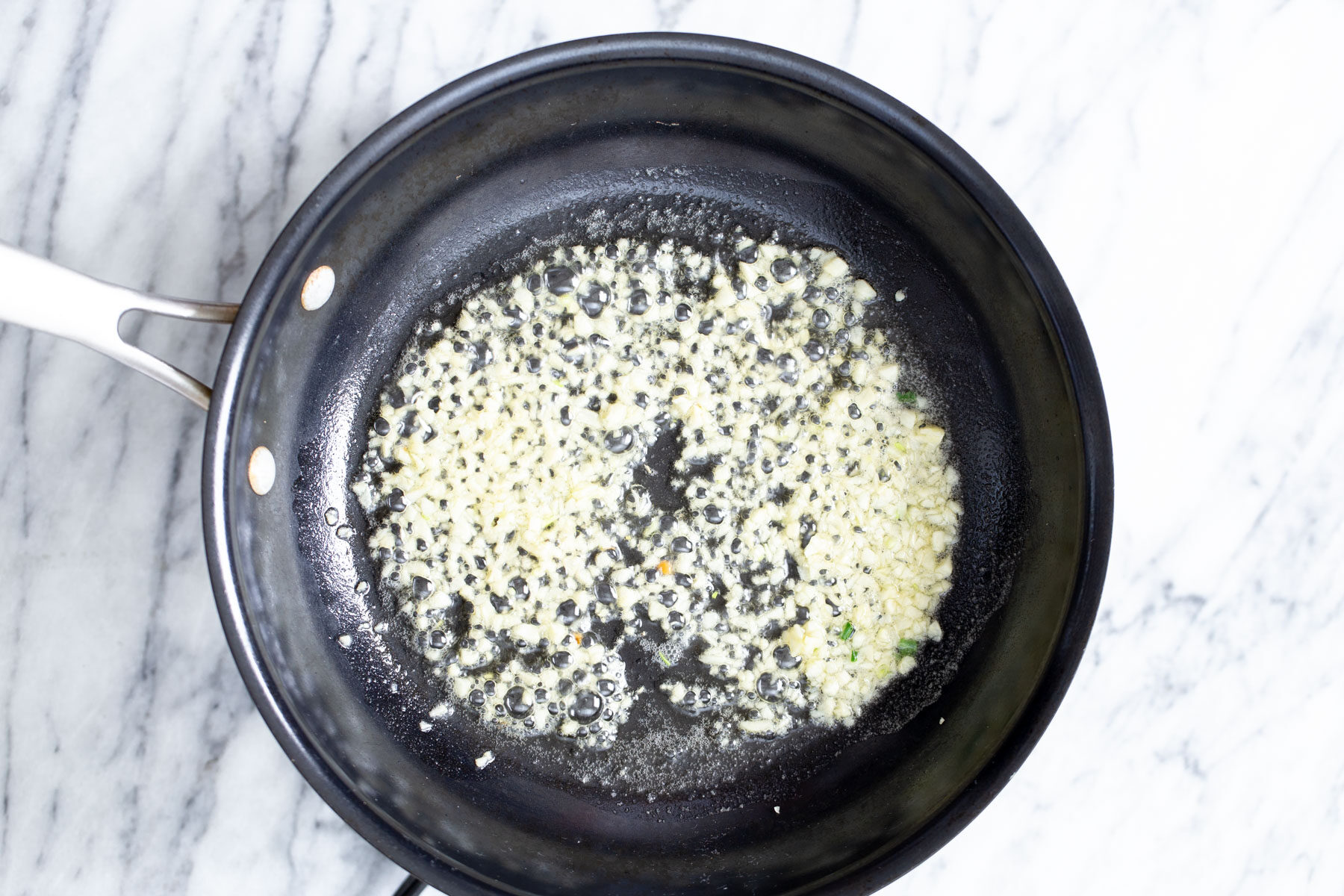 garlic being fried in a pan