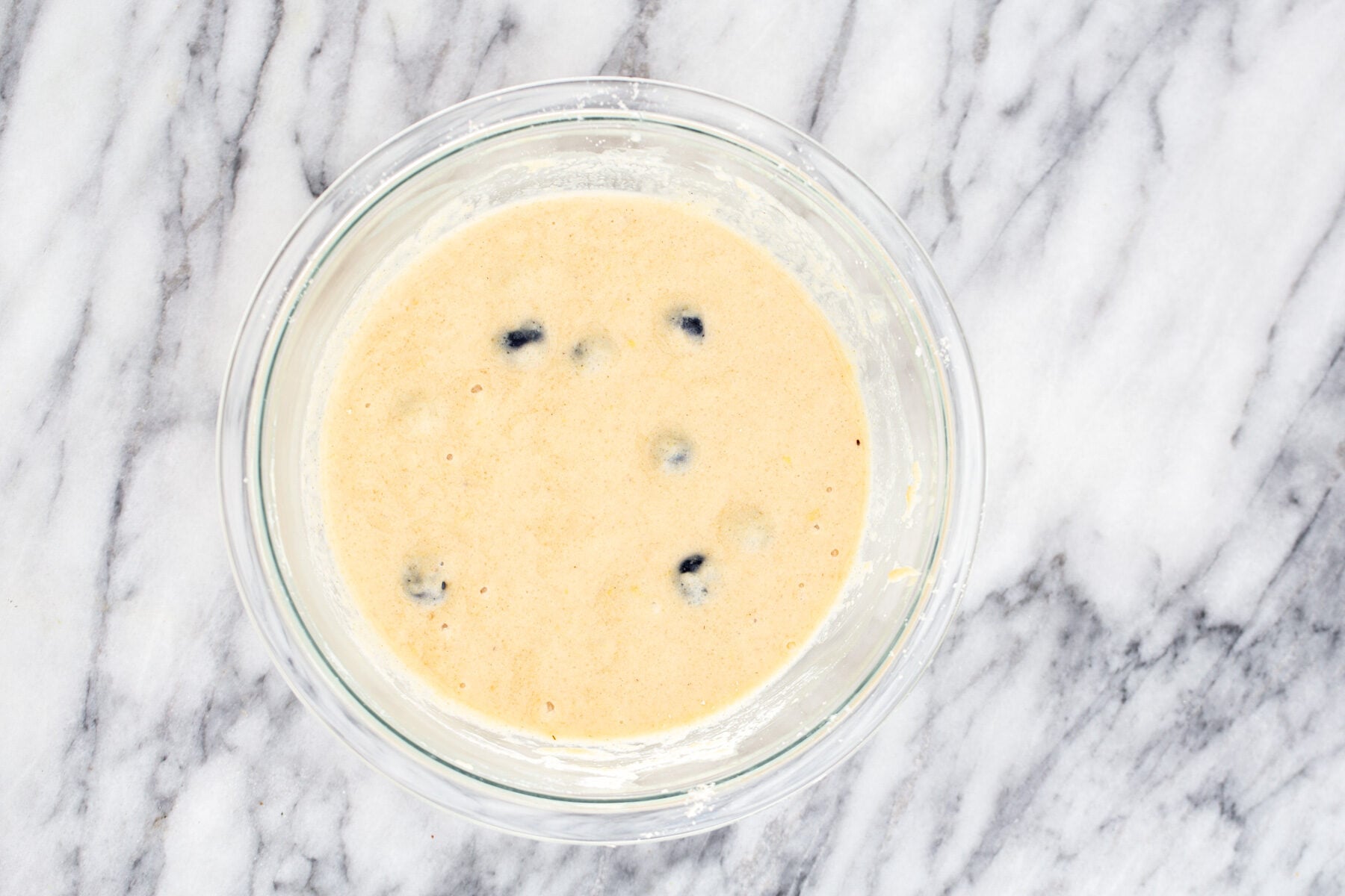 lemon blueberry waffles a glass bowl with glutenfree waffle batter with blueberries and lemon zest