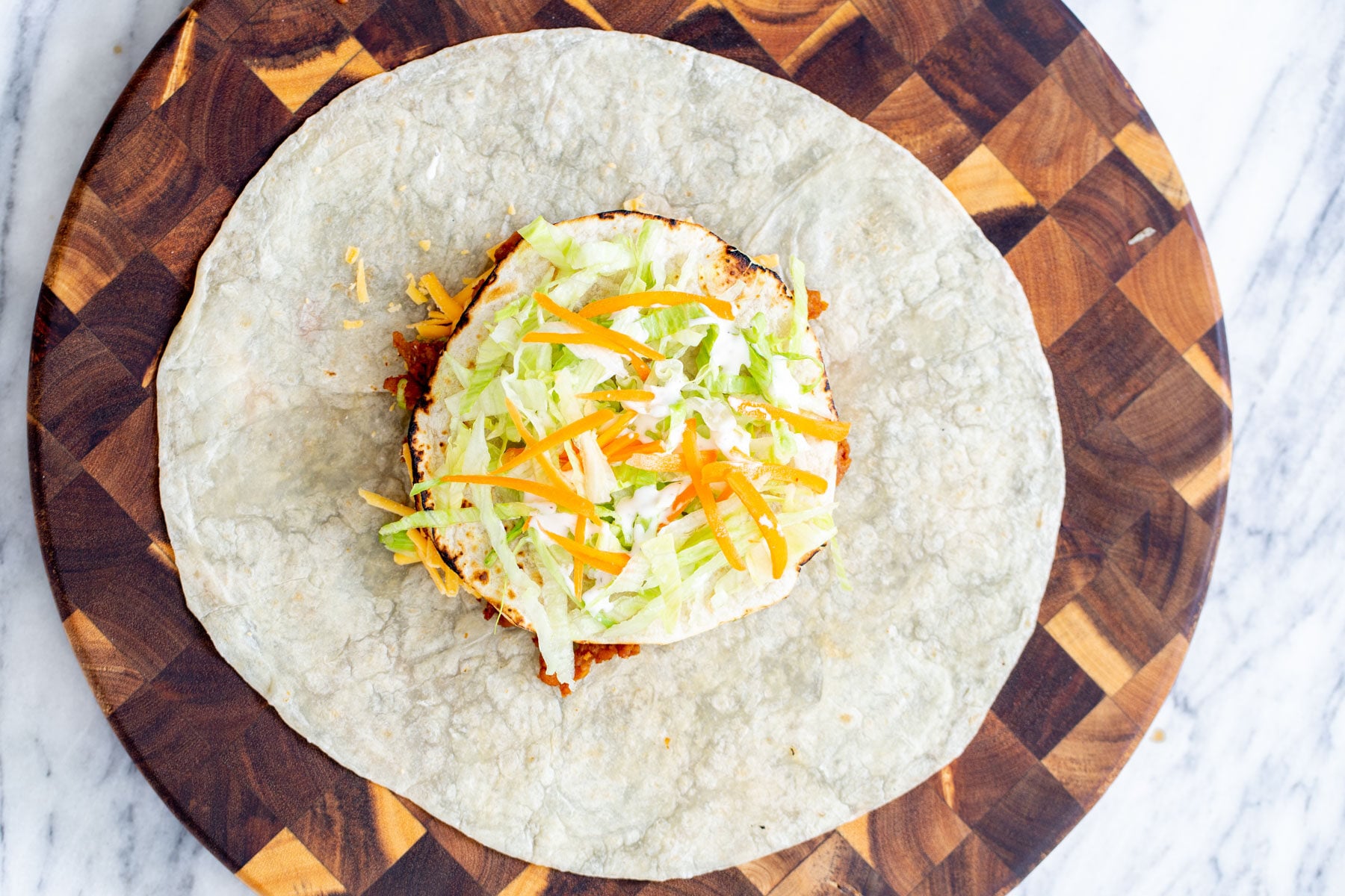 vegan crunchwrap vegan crunchwrap with toppings ready to be folded and toasted