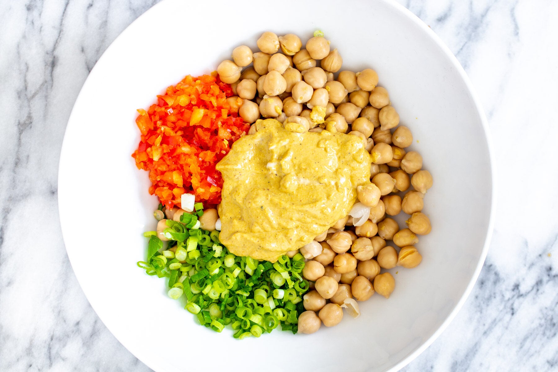 ingredients for vegan chickpea scramble in a white bowl 