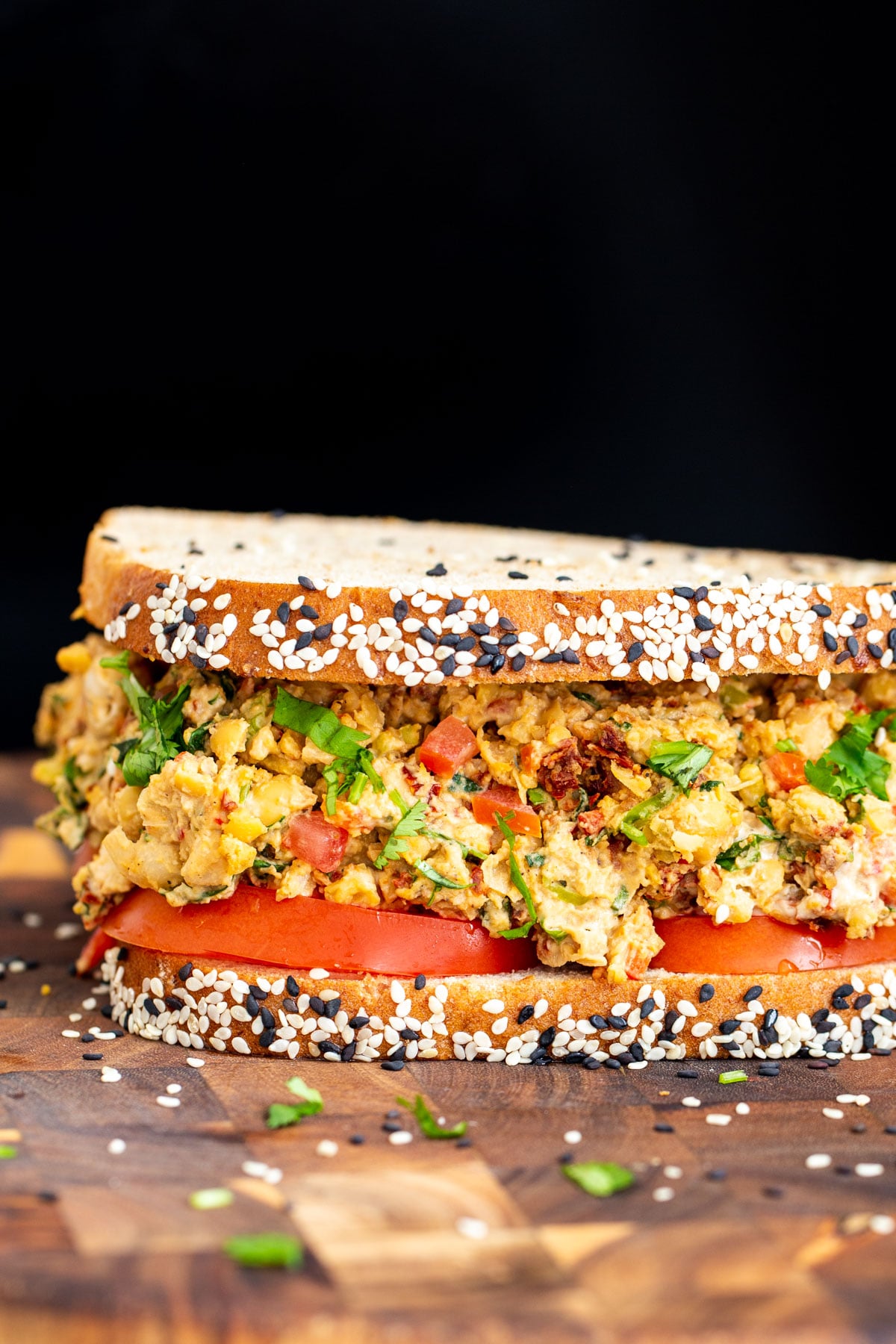 Mediterranean sandwich close up side view of vegan Mediterranean chickpea sandwich