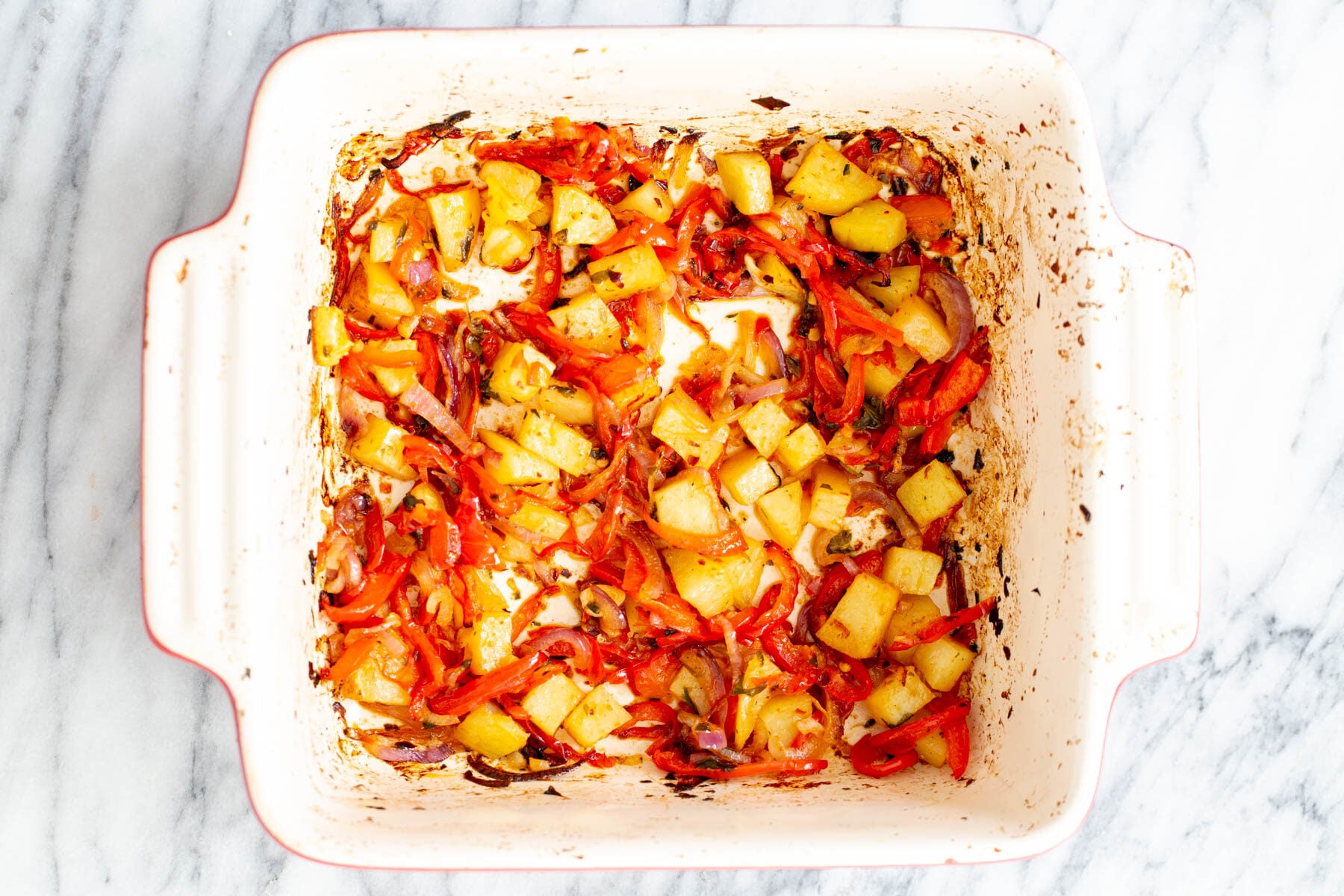 vegan Mexican casserole roasted bell peppers, onion and potatoes in a casserole dish