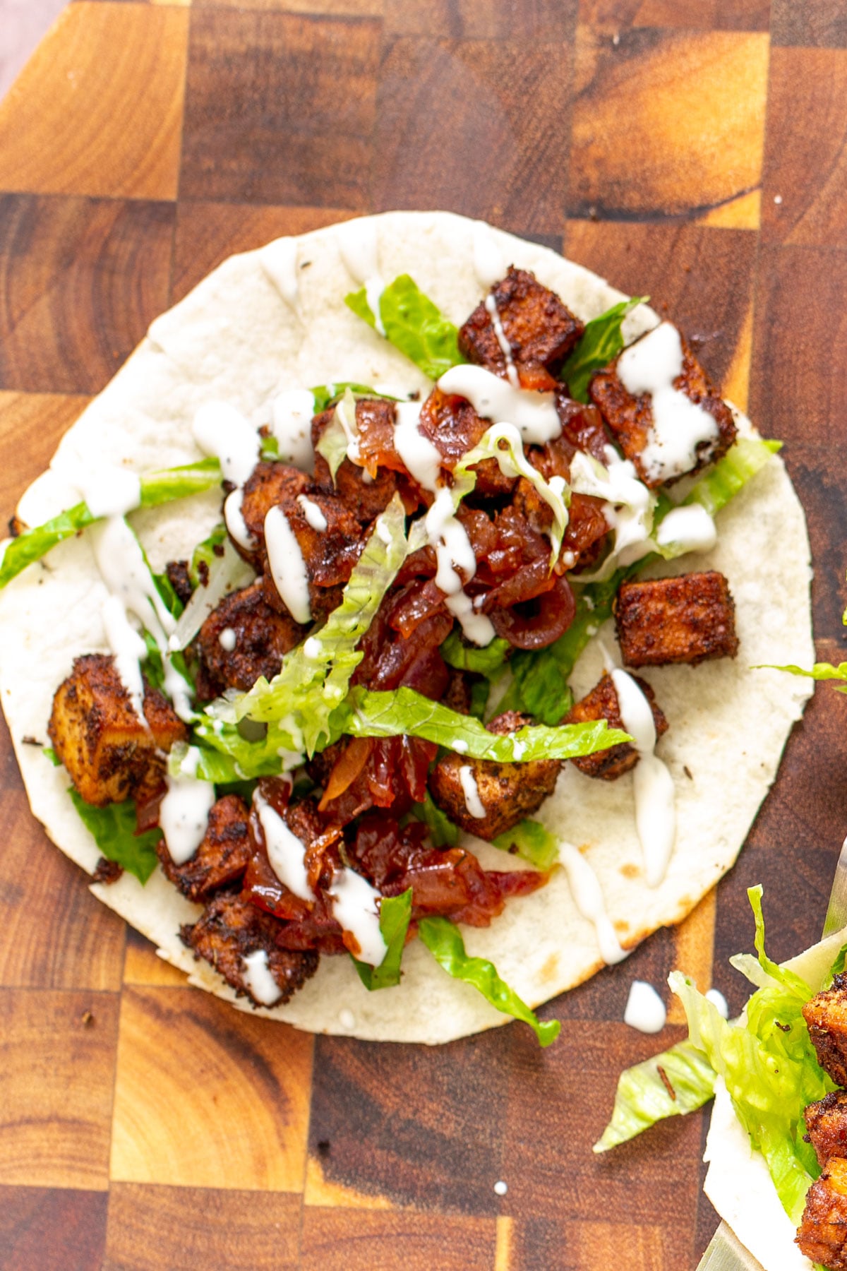 blackened tofu taco tortilla topped with blackened tofu, caramelized onion and sour cream