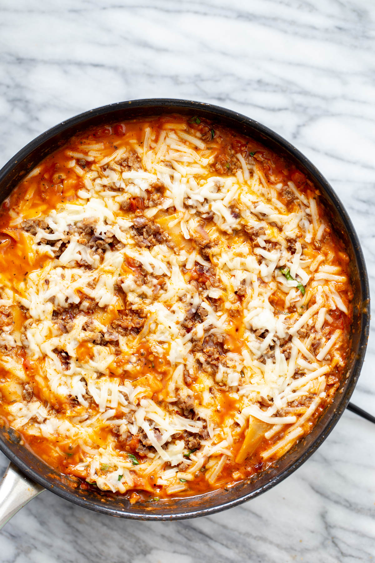 vegan skillet lasagna vegan skillet lasagna with vegan cheese shreds in a black iron skillet