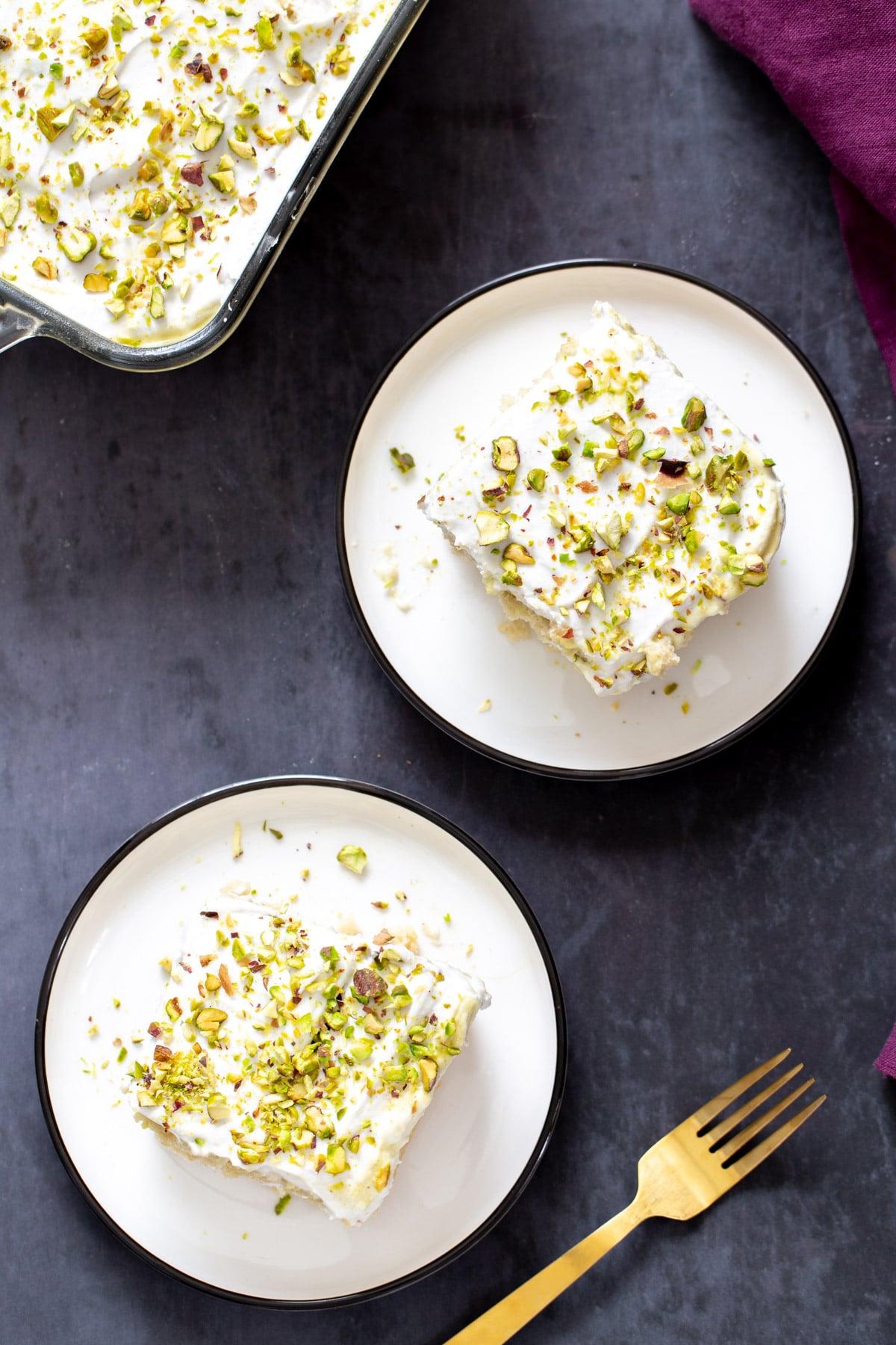 vegan tres leches overhead shot of two slices of vegan tres leches sprinkled with pistachios