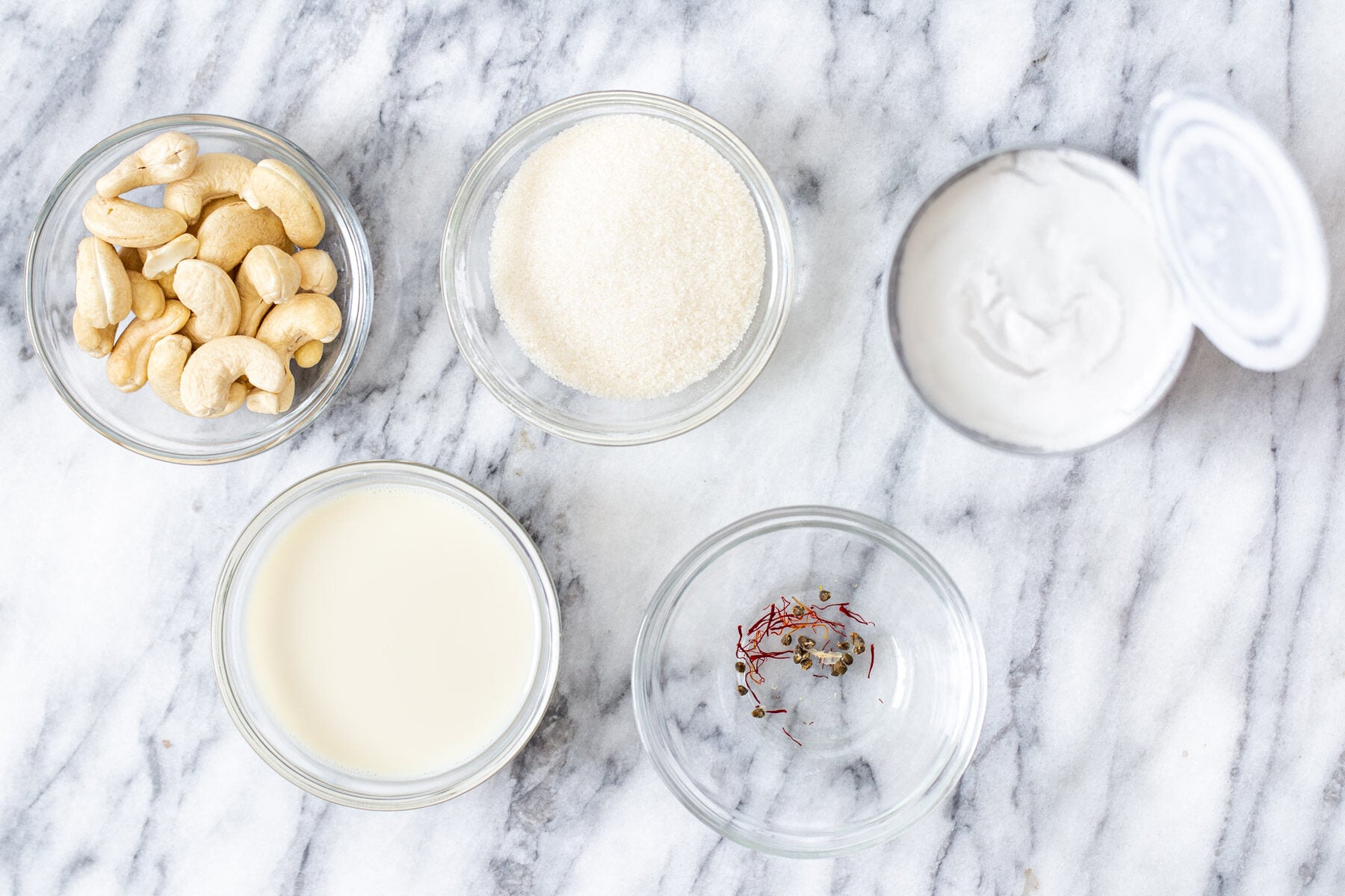 Ingredients for the soaking rasmalai milk in bowls “ width=