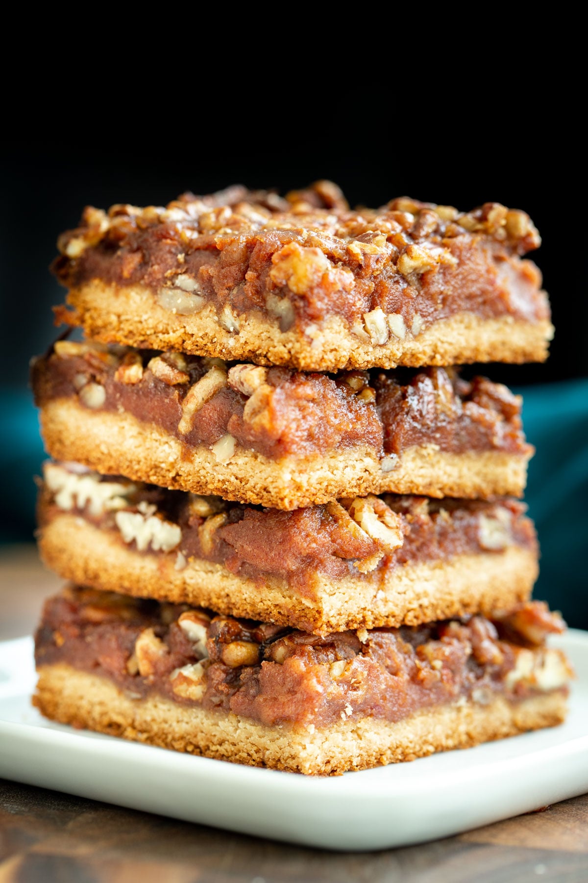 vegan pecan pie bars a stack of vegan glutenfree pecan pie bars on a white plate