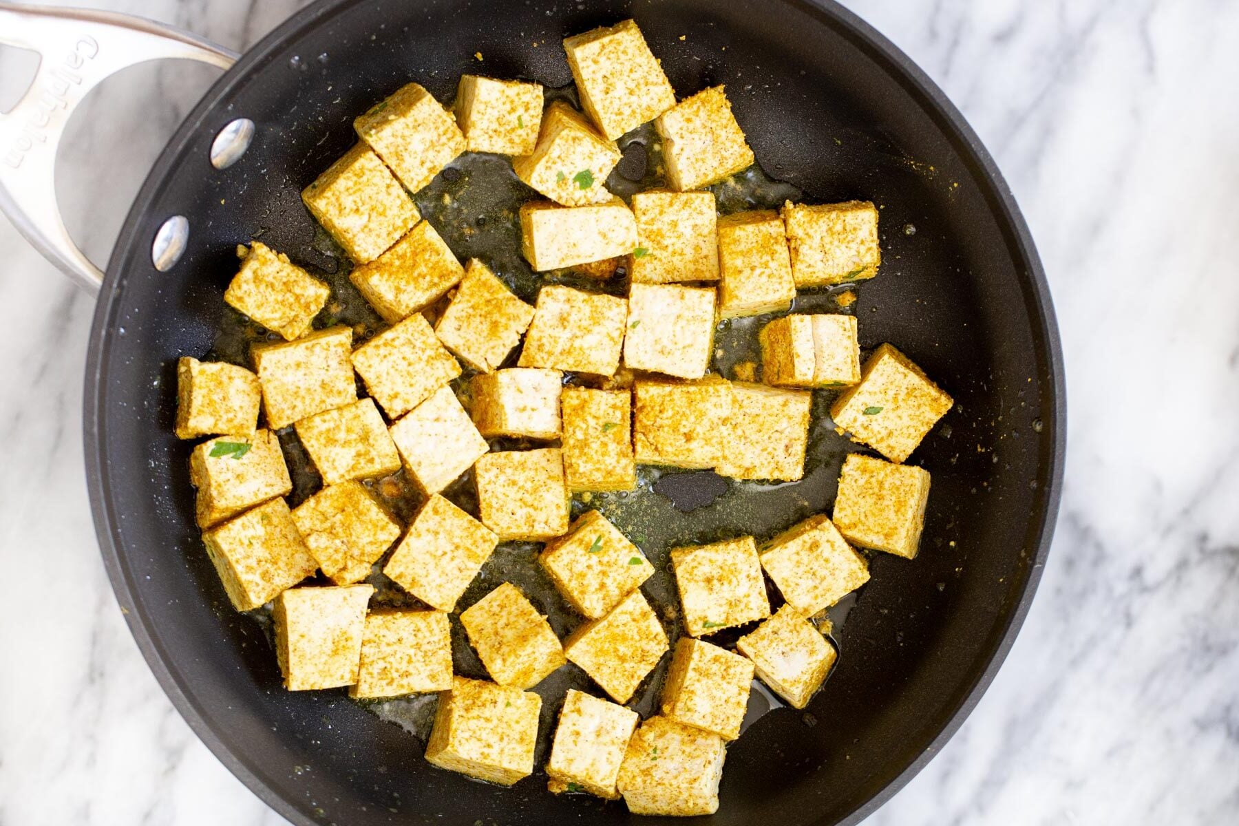 tofu malai tofu cubes being fried in a sauteeing pan