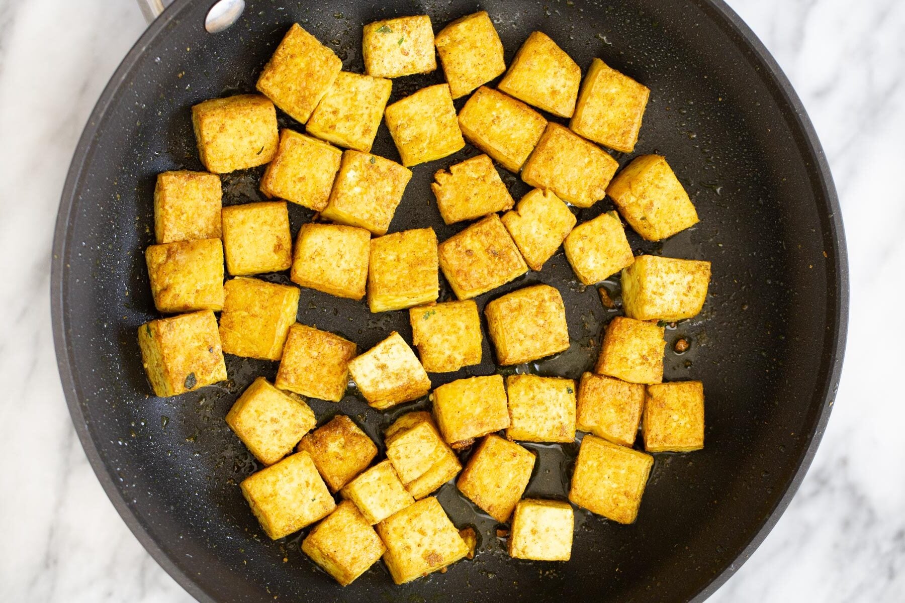 tofu malai tofu cubes being sauteed in a s frying pan