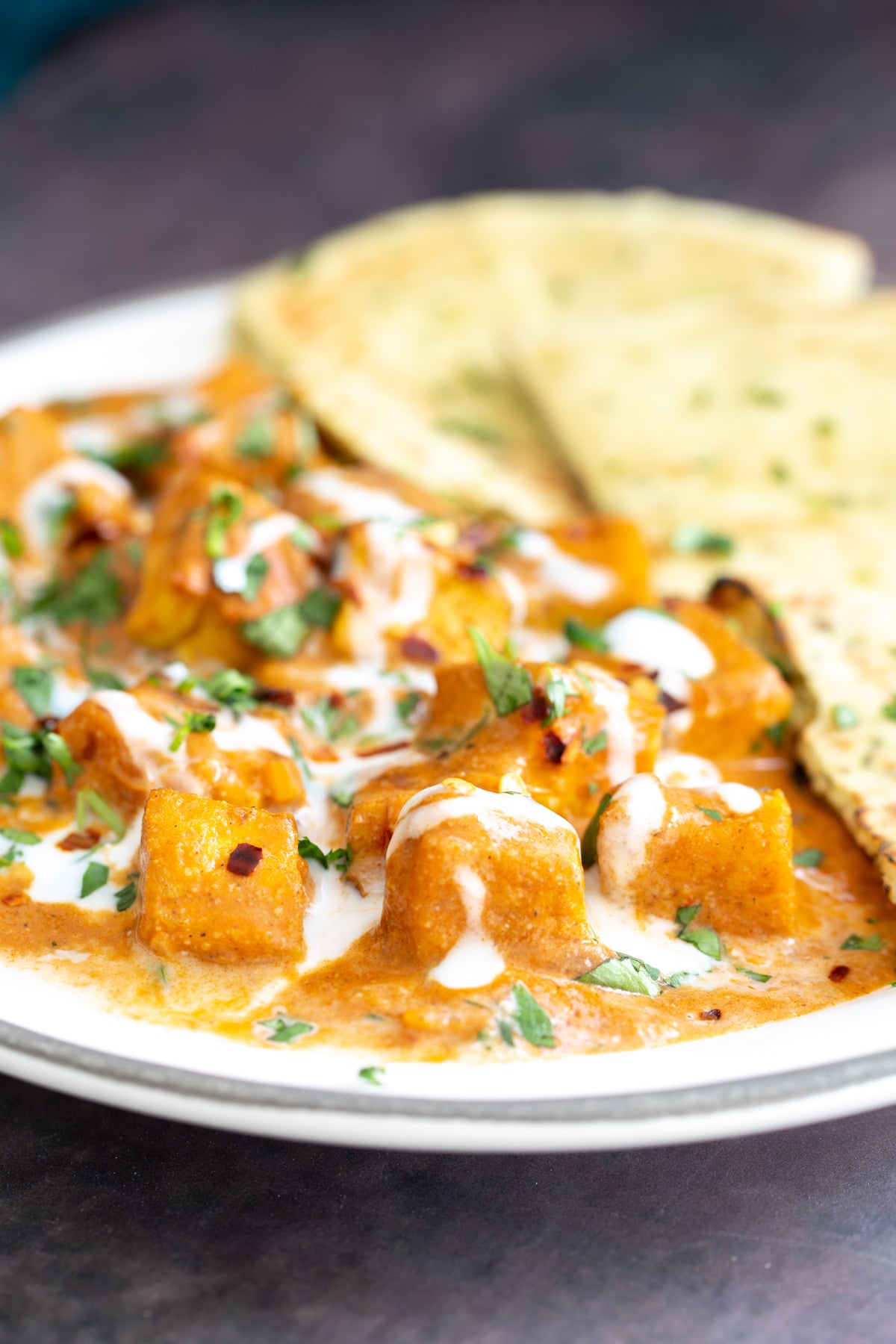 malai tofu tofu malai curry drizzled with coconut cream served with a side of naan bread