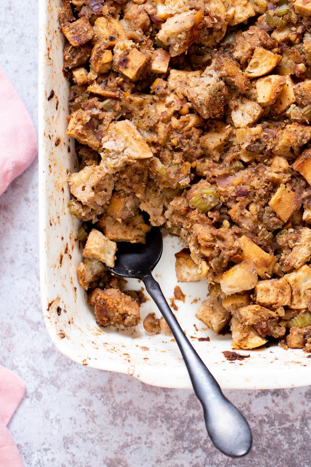 vegan stuffing vegan stuffing in a white casserole dish with a spoon