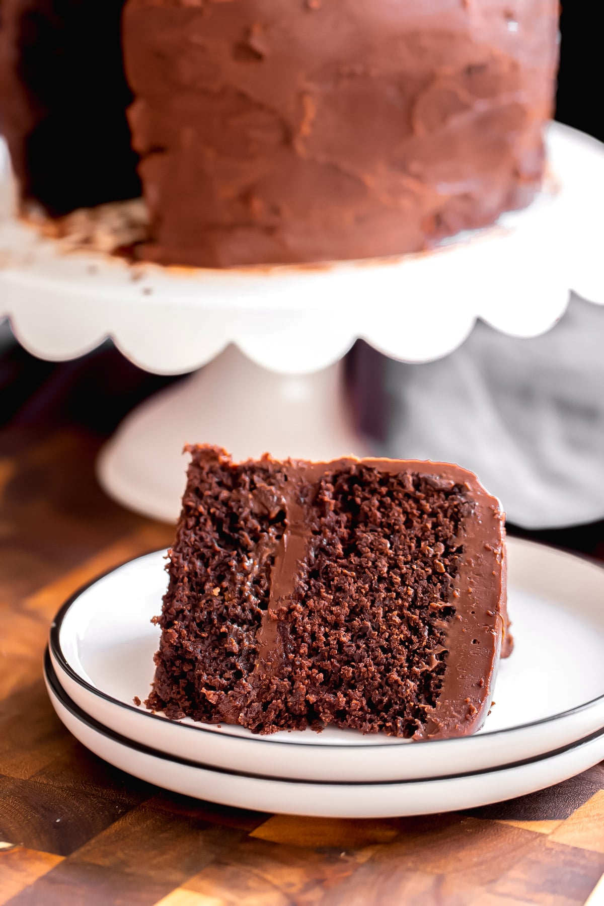 a slice of vegan chocolate layer cake on a plate