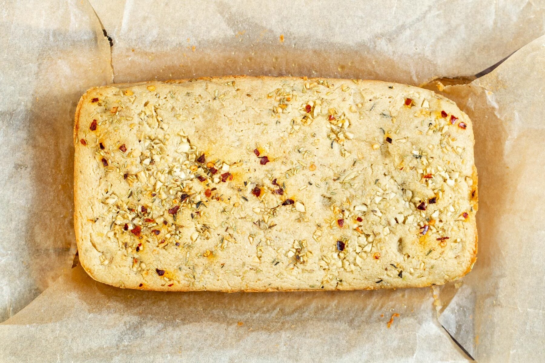 glutenfree focaccia a loaf of glutenfree focaccia on parchment paper