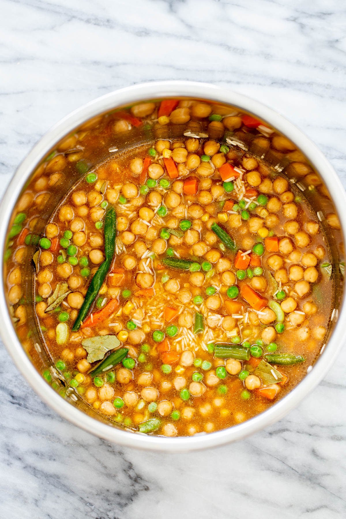 chickpea fried rice broth being added to dry ingredients to make chickpea fried rice