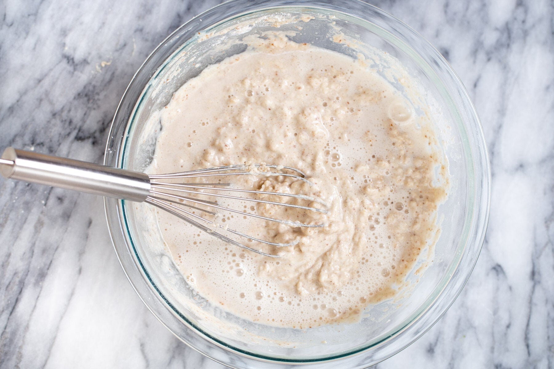 vegan sheet pan pancakes club soda being added to pancake batter to make sheet pan pancakes
