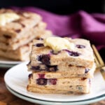 vegan sheet pan pancakes stacked on a white plate
