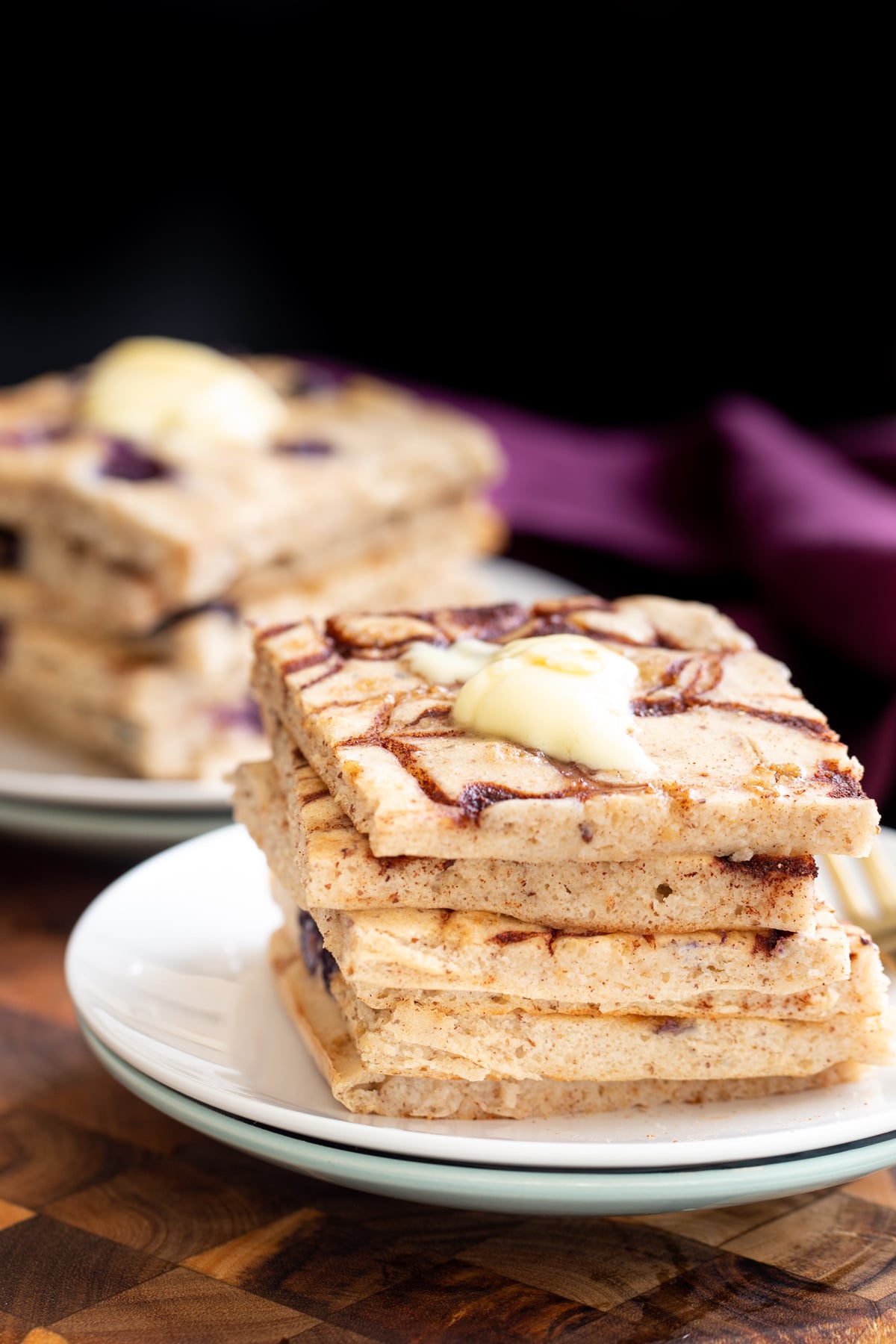 vegan sheet pan pancakes vegan cinnamon swirl sheet pan pancakes stacked on a white plate