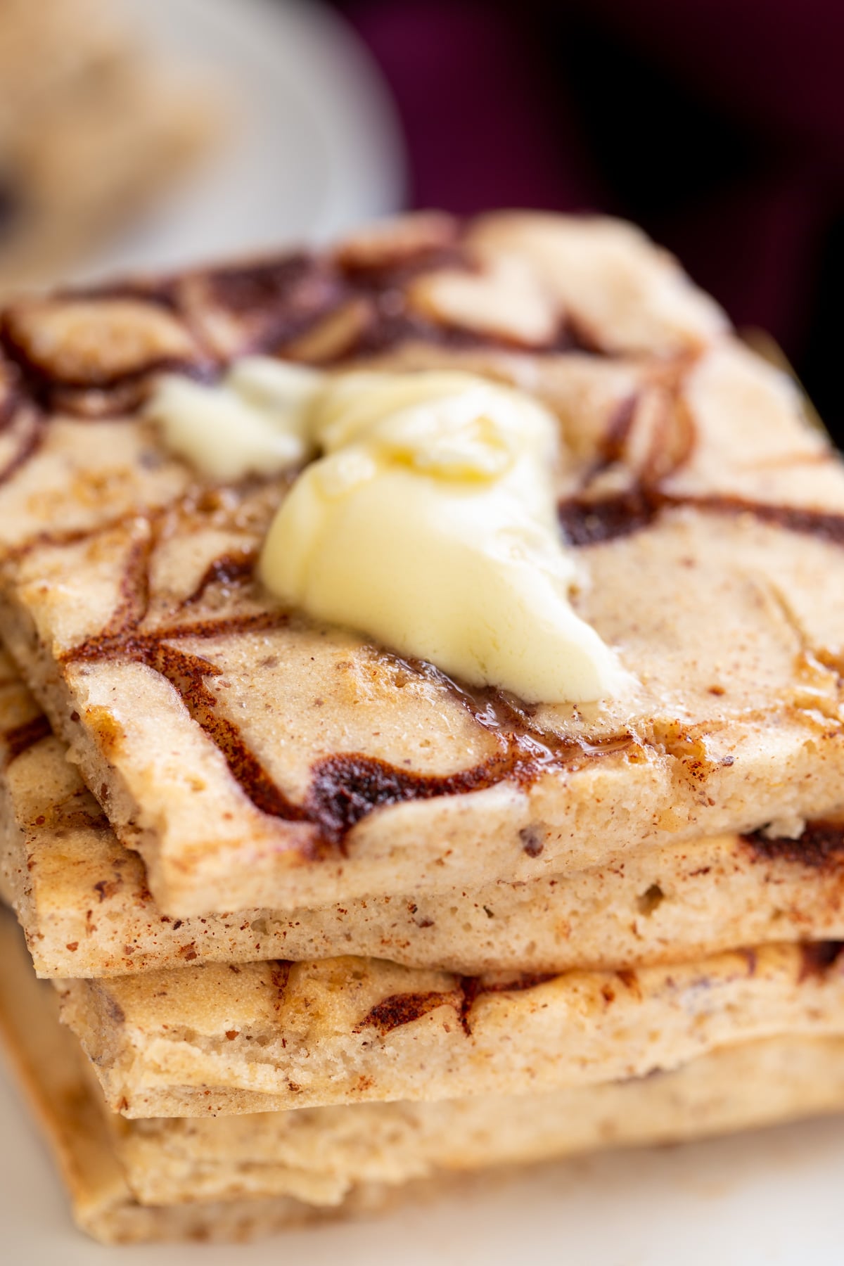 vegan cinnamon swirl sheet pan pancakes topped with a dollop of vegan butter