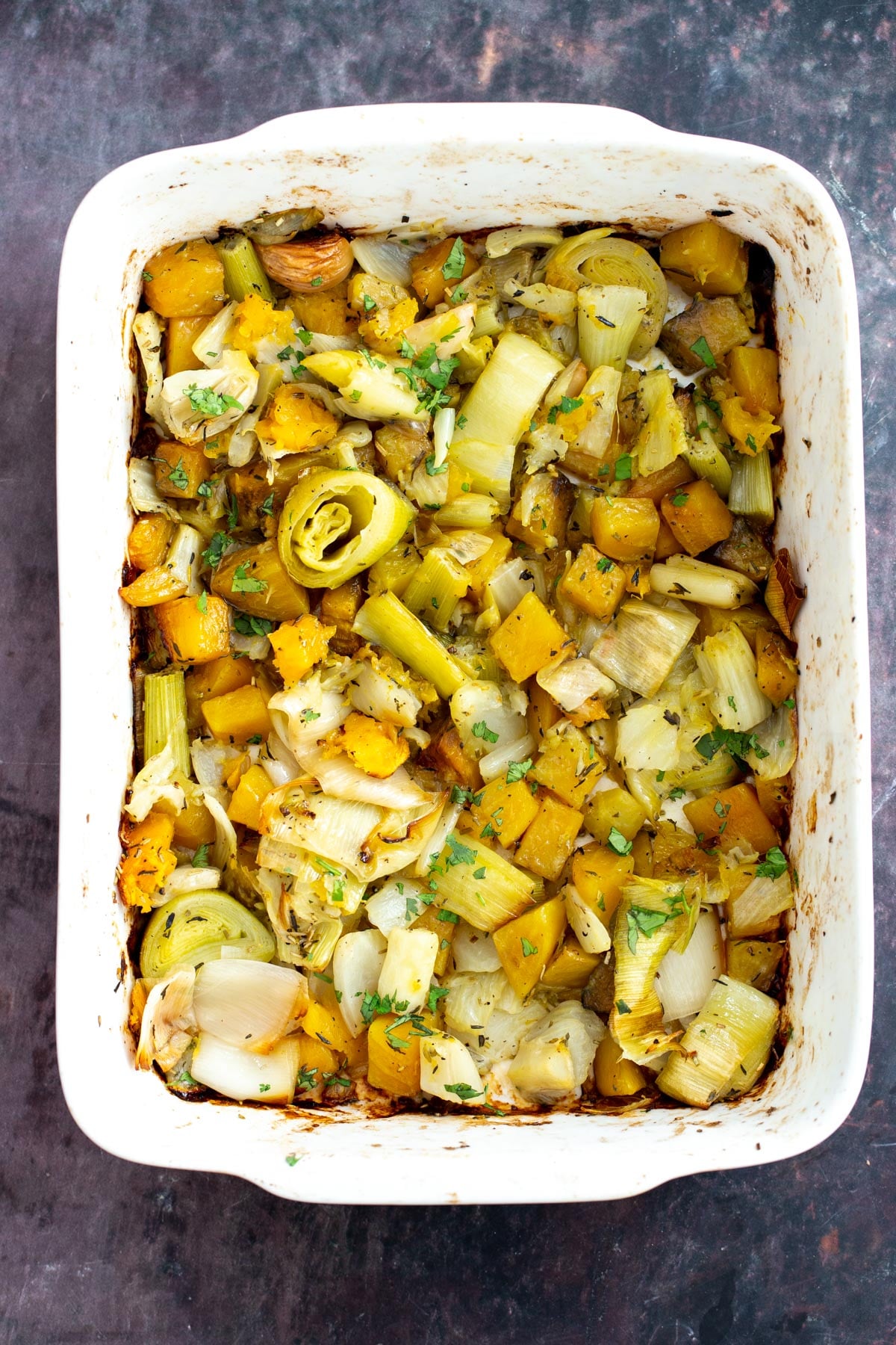 roasted golden beets, fennel and leek in a casserole dish 