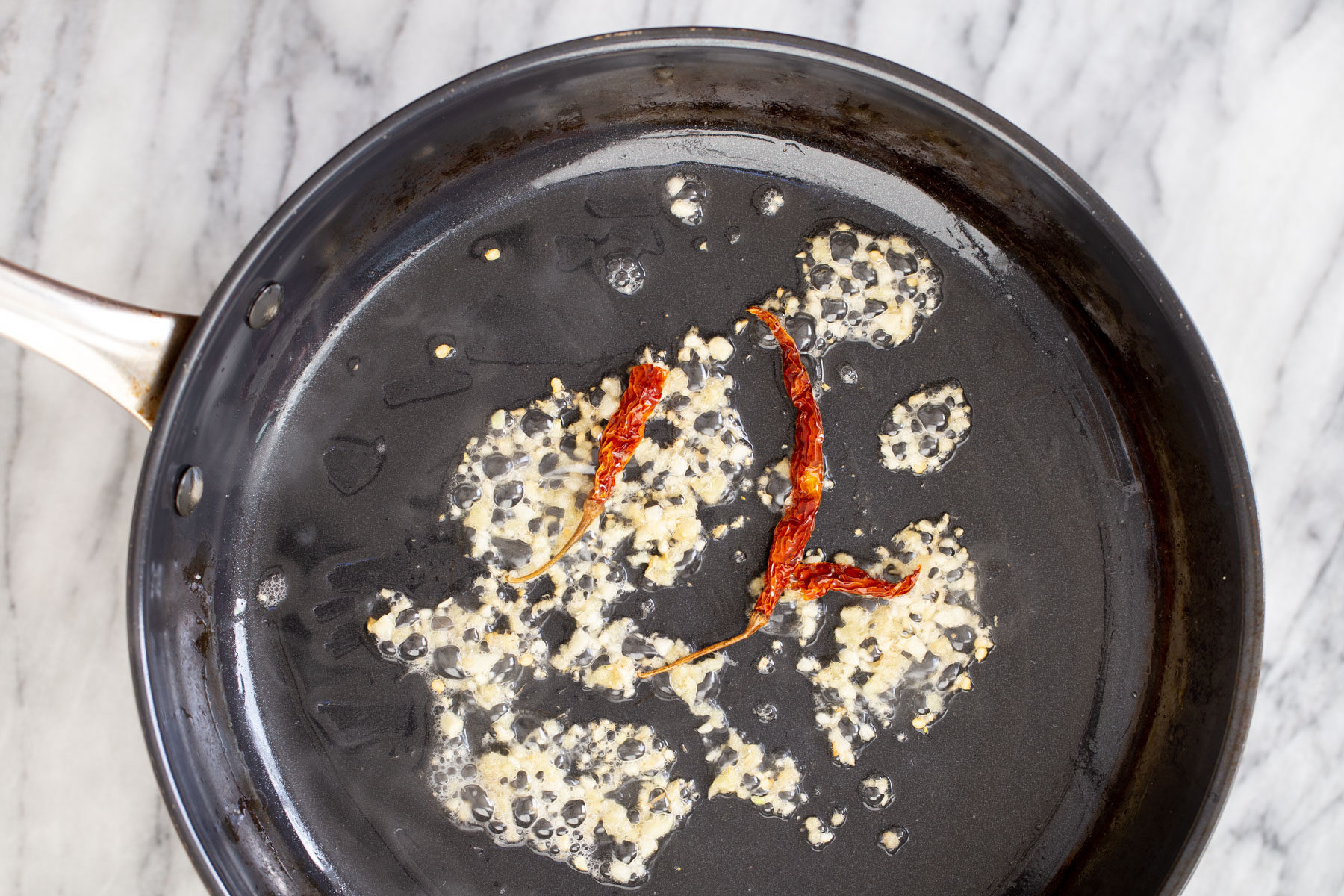 sauteeing pan with minced garlic and chile