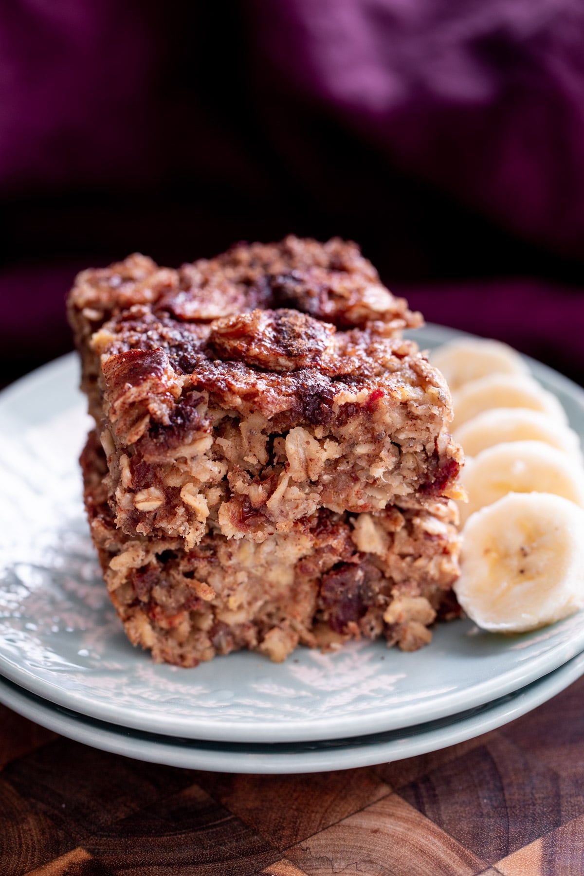 banana oatmeal bars stacked vegan banana oatmeal bars on a white plate