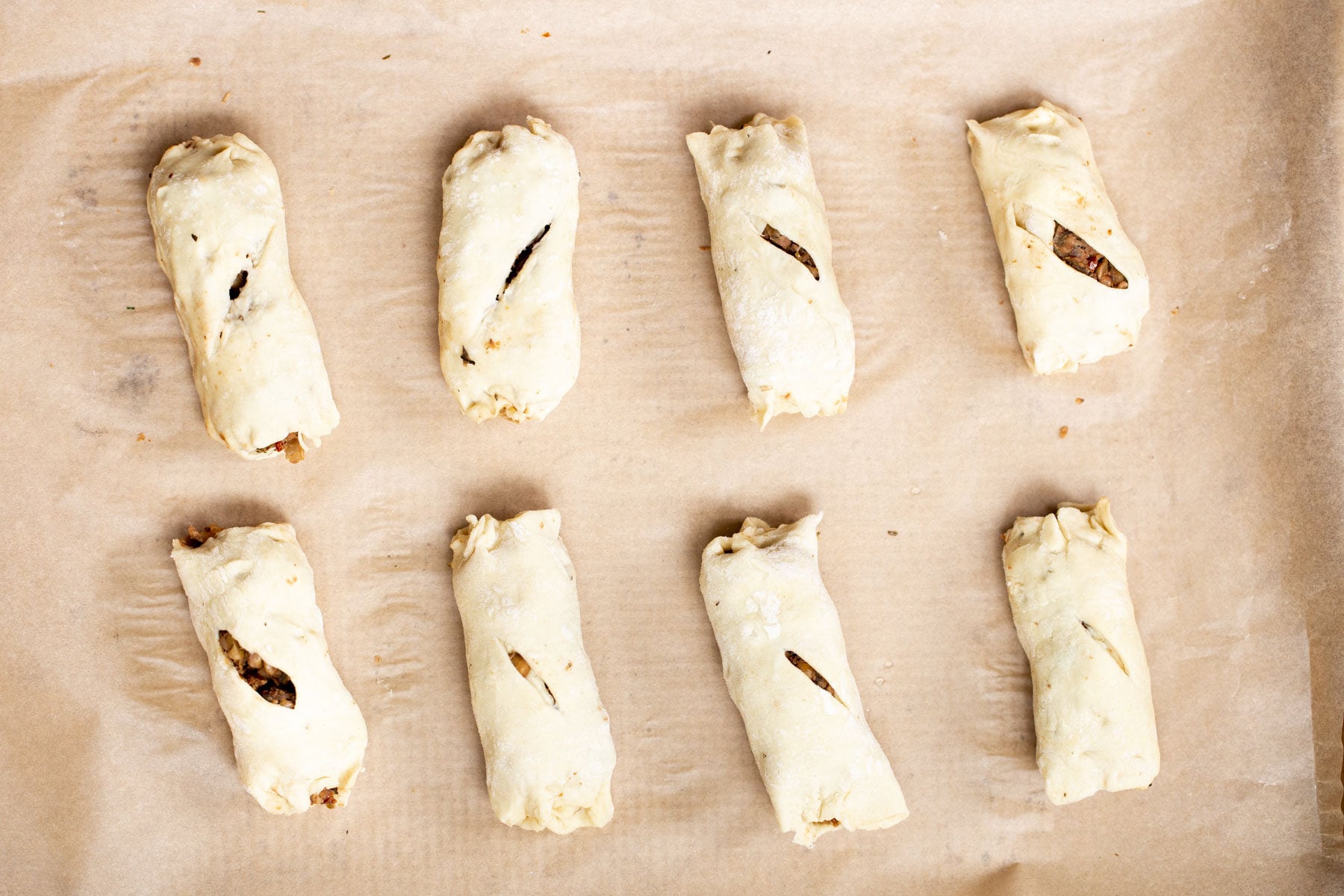 vegan sausage rolls vegan sausage rolls on a sheet of parchment paper