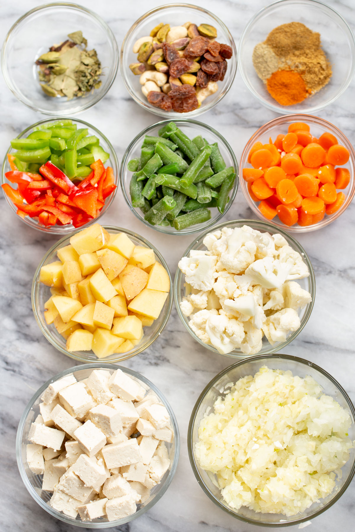 Navratan Korma ingredients on a marble countertop